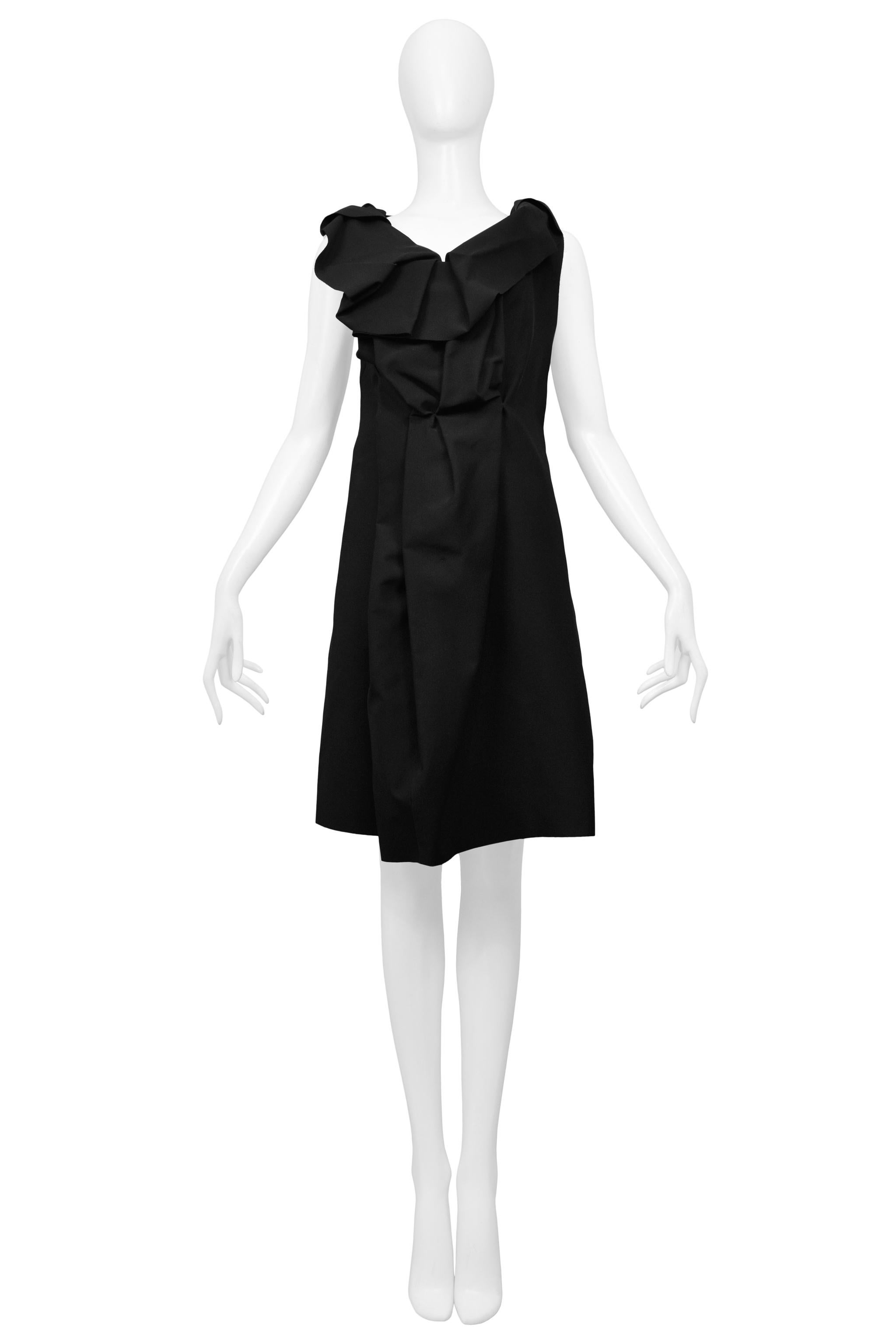 Resurrection Vintage is excited to offer a vintage Maison Martin Margiela black silk dress featuring a deconstructed ruffle yoke and front pleating.

Maison Martin Margiela
Size 42
Silk
Made in Italy
Excellent Vintage Condition
Authenticity