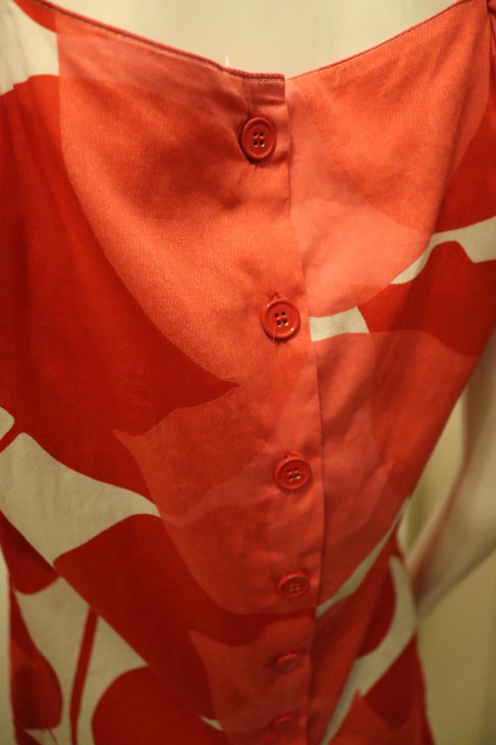 A colourful and fun vintage cotton top by Marimekko , the Finnish designer. 
In a stunning red , pink and white print the top has puff sleaves and a button opening at the back. It is unlined. Size 34 Measurements: Bust 35'', length 24''