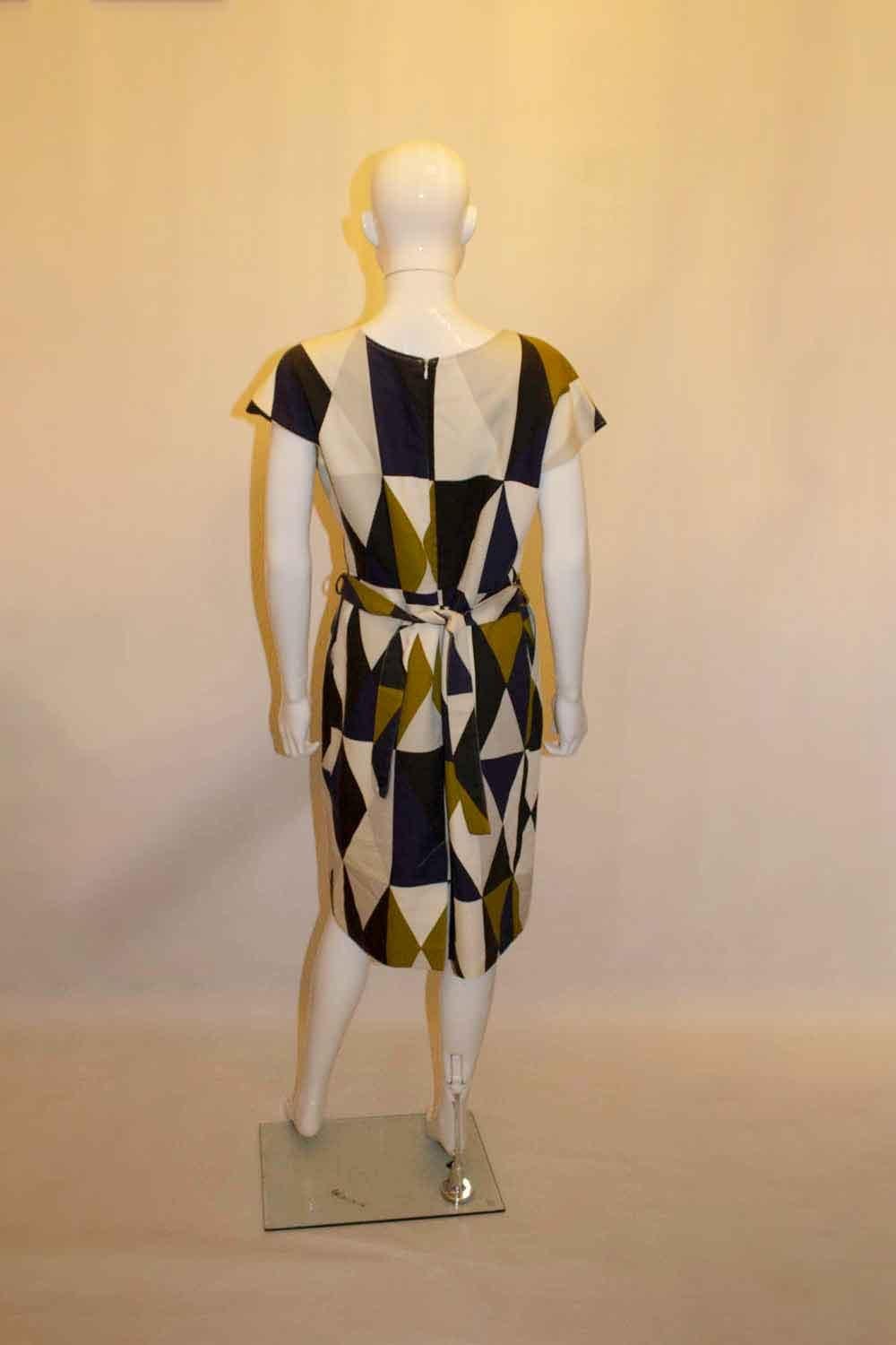A headturning outfit by Finnish designer Marimekko. In a wonderful brown , black and white print, the jacket is size 38 and measures Bust up to 40'', length 18''. The dress has a self fabric belt, 2 pockets at the front and a zip opening at the back