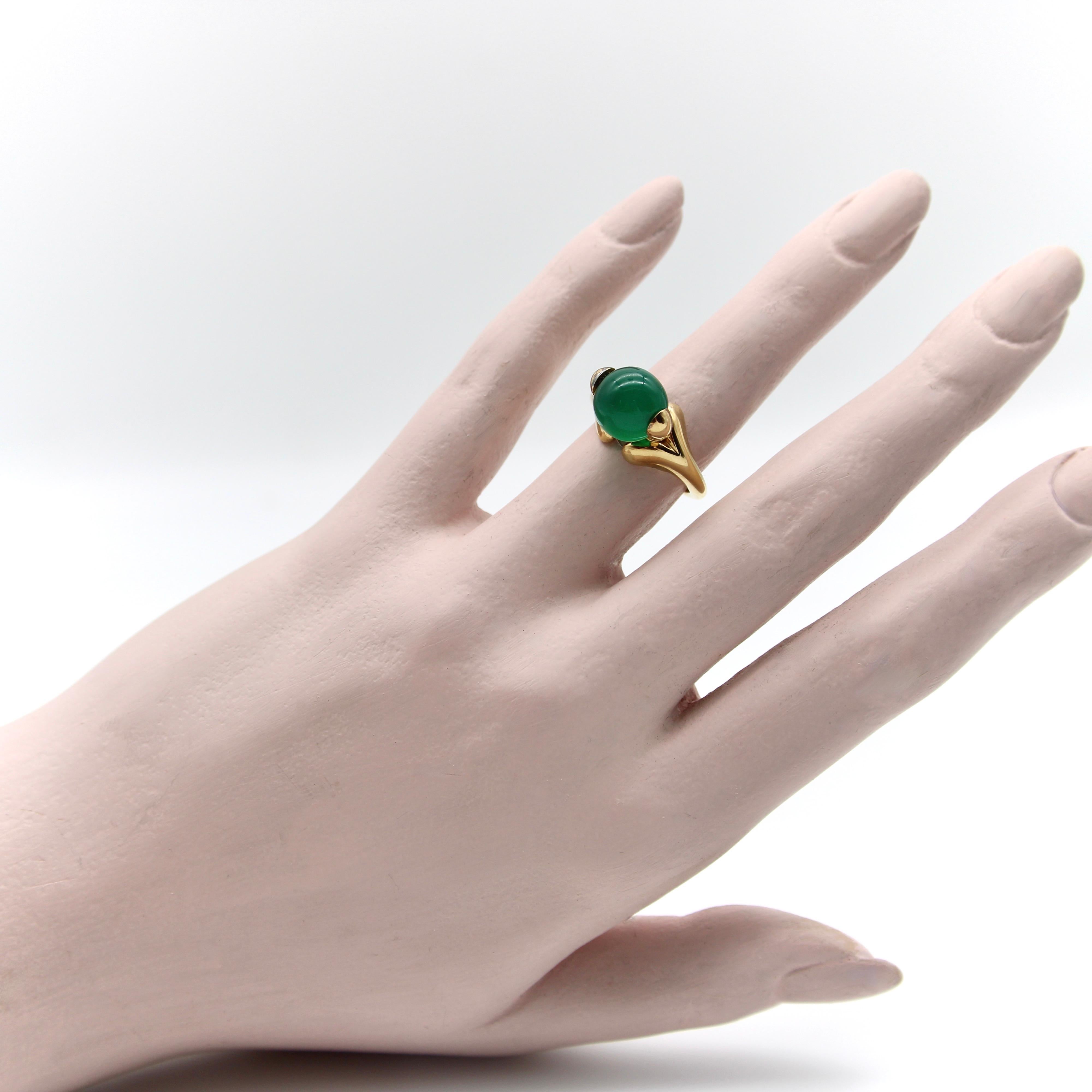This 18k gold ring by Marina B features a pierced chalcedony bead that spins on the top in a playful and bold fashion. The ring is hallmarked Marina B, 750, with the stye # 180033. We’ve been unable to find many rings similar to this one. The ring