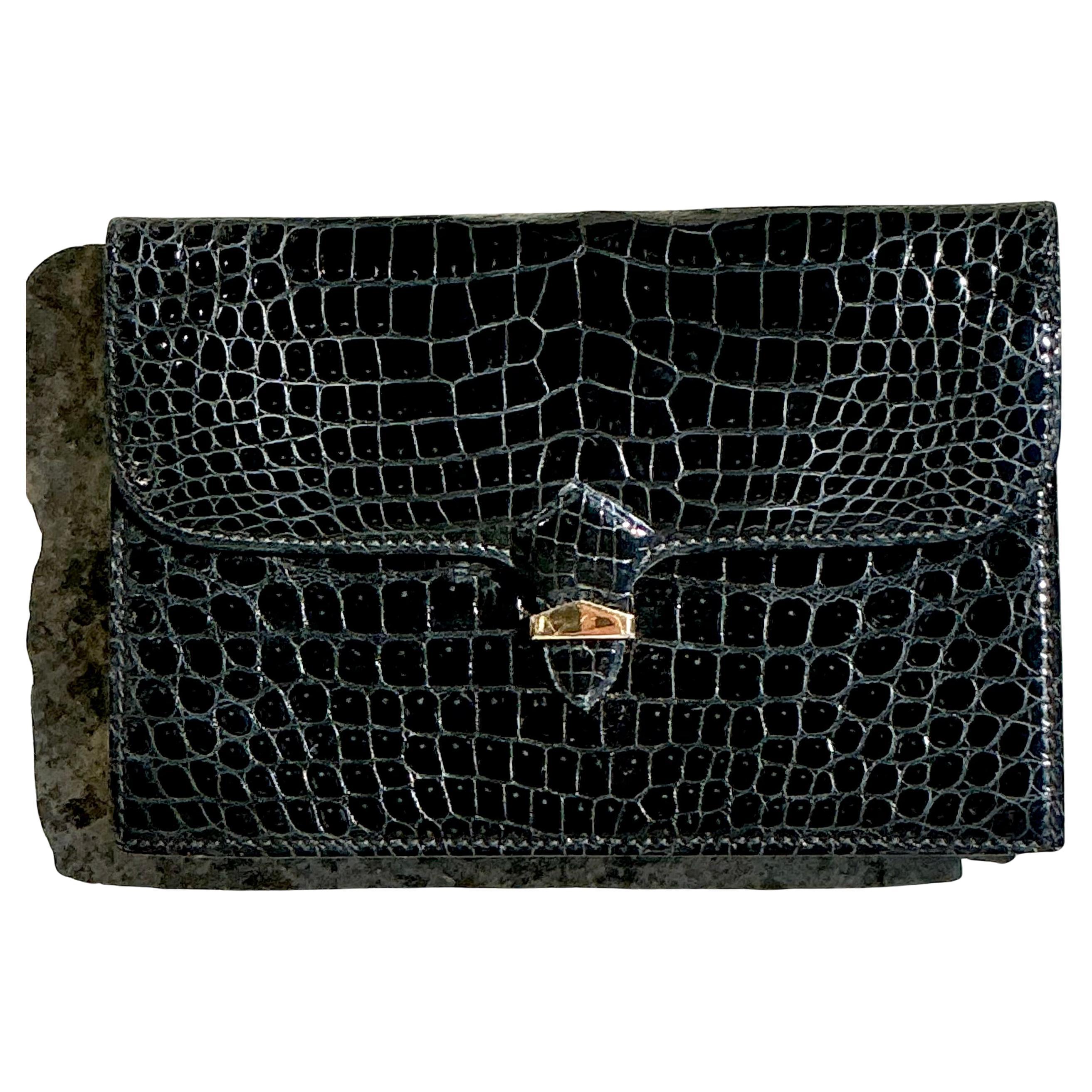 The Vintage Mark Cross England Crocodile Clutch is a luxurious and timeless accessory that epitomizes high-end craftsmanship and elegant design. Made from genuine crocodile leather and featuring the iconic Mark Cross branding, this clutch is a