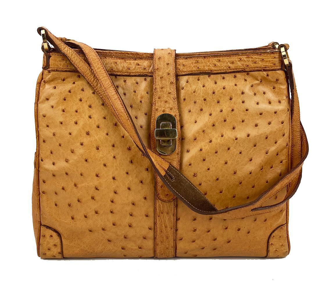 Vintage Mark Cross Tan Ostrich Shoulder Bag in excellent condition. Tan ostrich exterior trimmed with gold hardware. Top leather strap with twist lock closure. Unique triple compartment design with centered zipped compartment and 2 exterior side