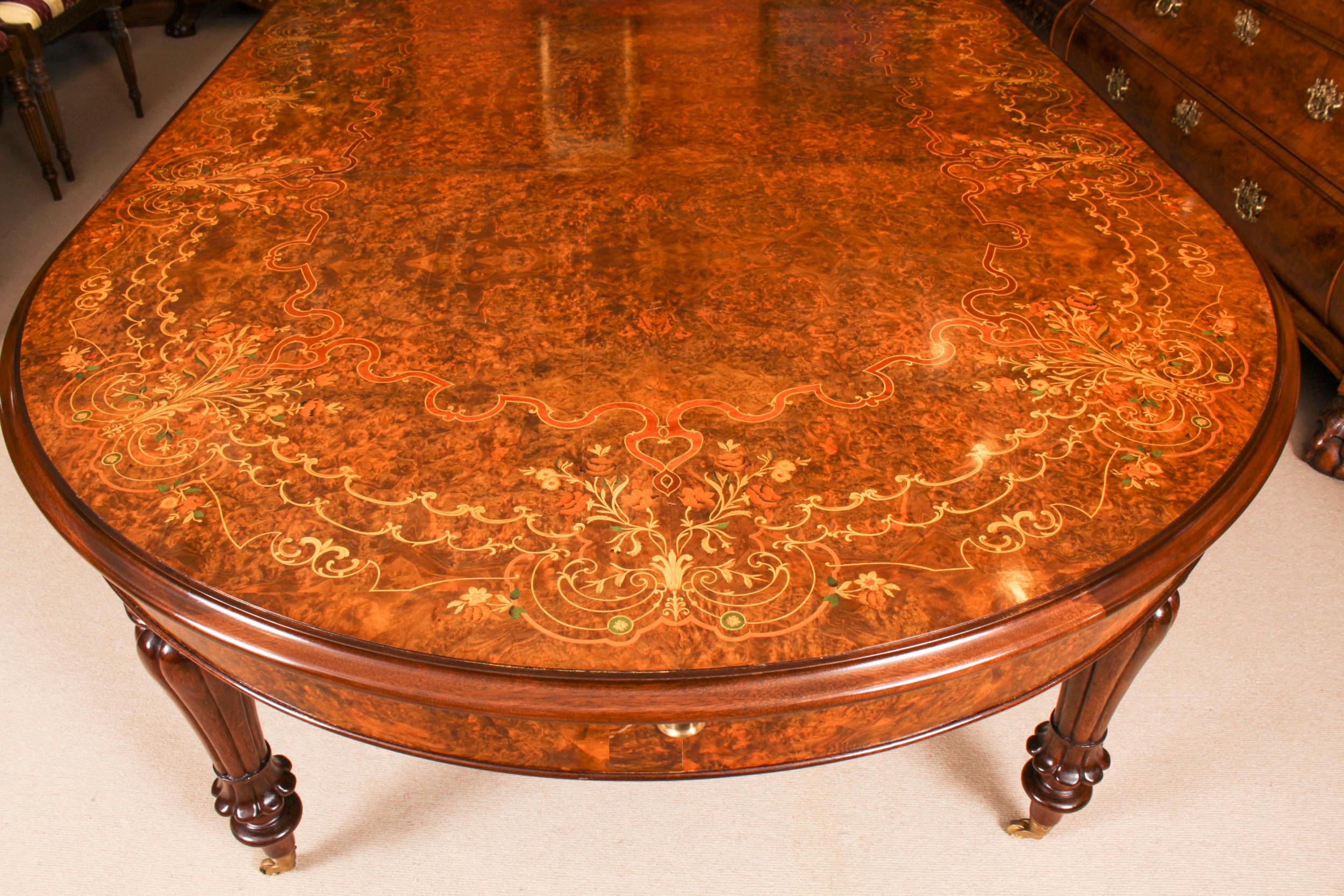 A truly fabulous vintage Victorian Revival dining set comprising a stunning burr walnut and floral marquetry dining table and a set of eight matching marquetry dining chairs, dating from the late 20th Century

The table is made from burr walnut