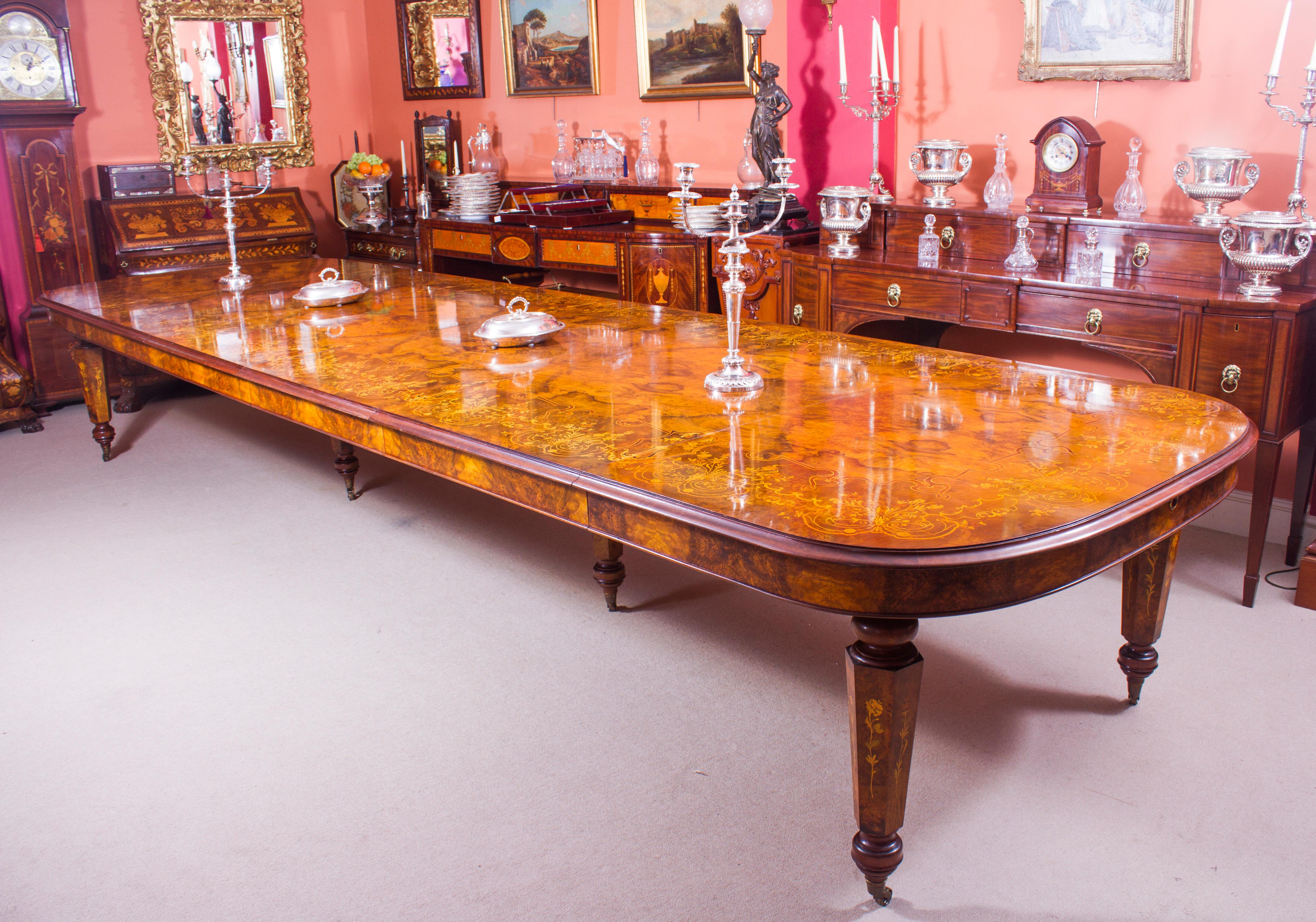 This is a fantastic Vintage Victorian Revival marquetry dining set, comprising a gorgeous burr walnut and marquetry D-End dining room table with the matching set of eighteen chairs, dating from the last quarter of the 20th Century.

The table is