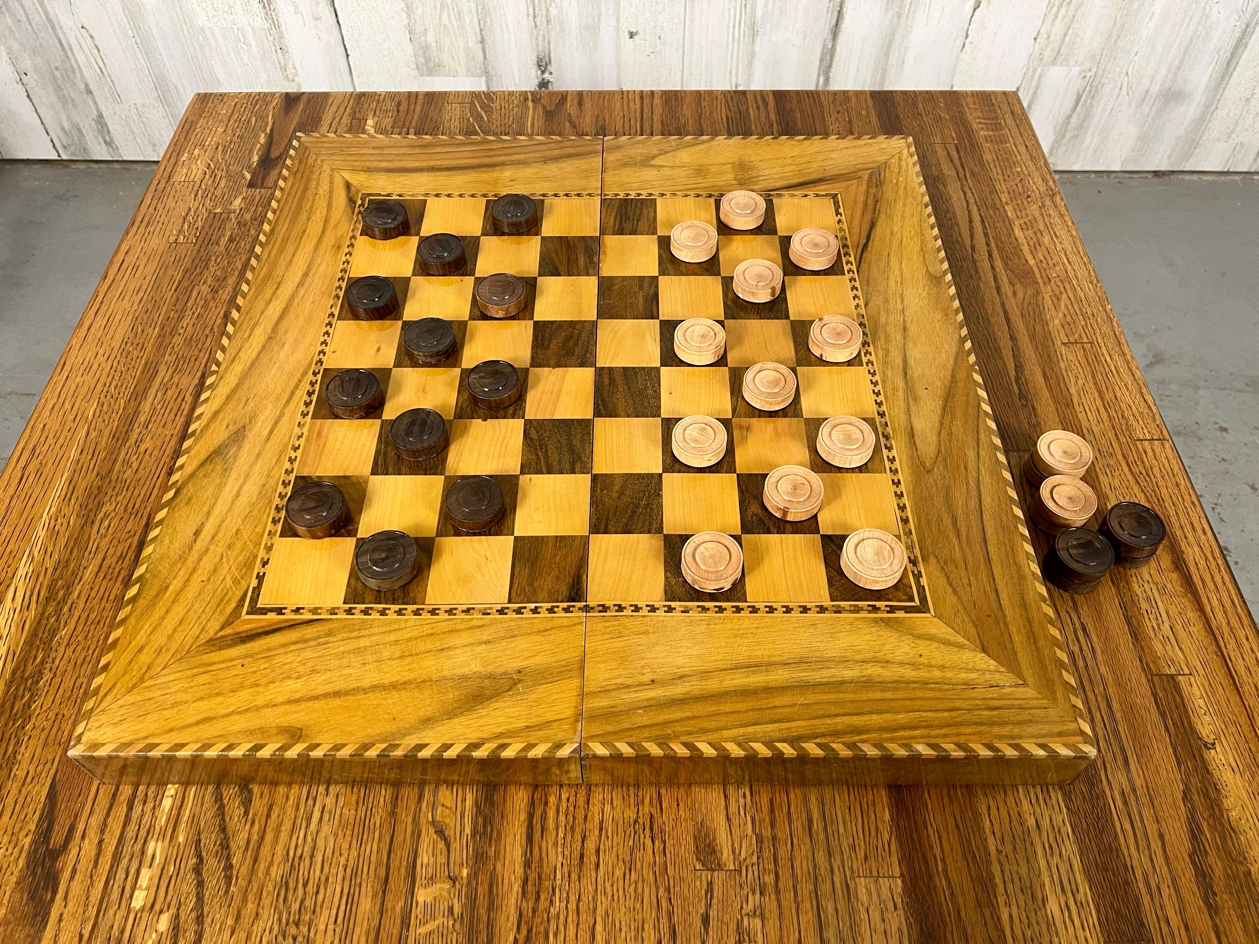 Beautiful marquetry design checker board with wood playing disc. Made for travel so it folds in half. Table not included.