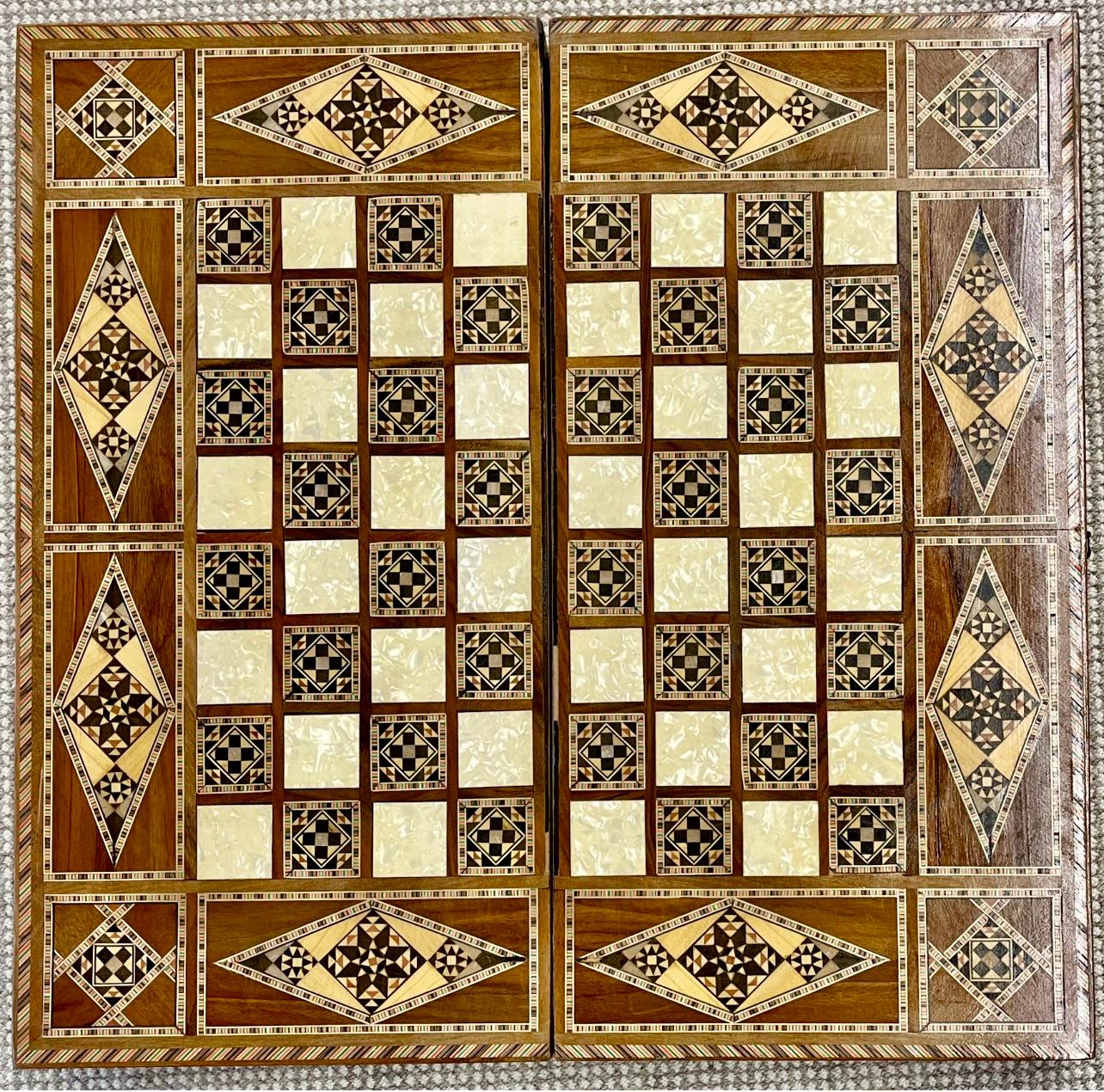 Vintage marquetry wood backgammon, chess case or board. This finely inlaid and intricately detailed board set has satinwood, rosewood and mother of pearl inlays. One side has a backgammon game board the opposite side has a full chess or checker