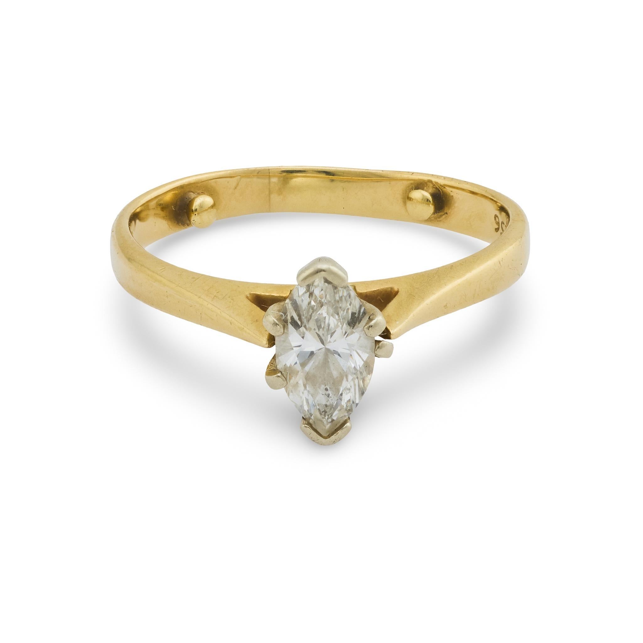 A graceful vintage 14k yellow gold ring set with a 0.70 carat marquise cut diamond of I color and SI clarity, offering timeless sparkle and elegance.