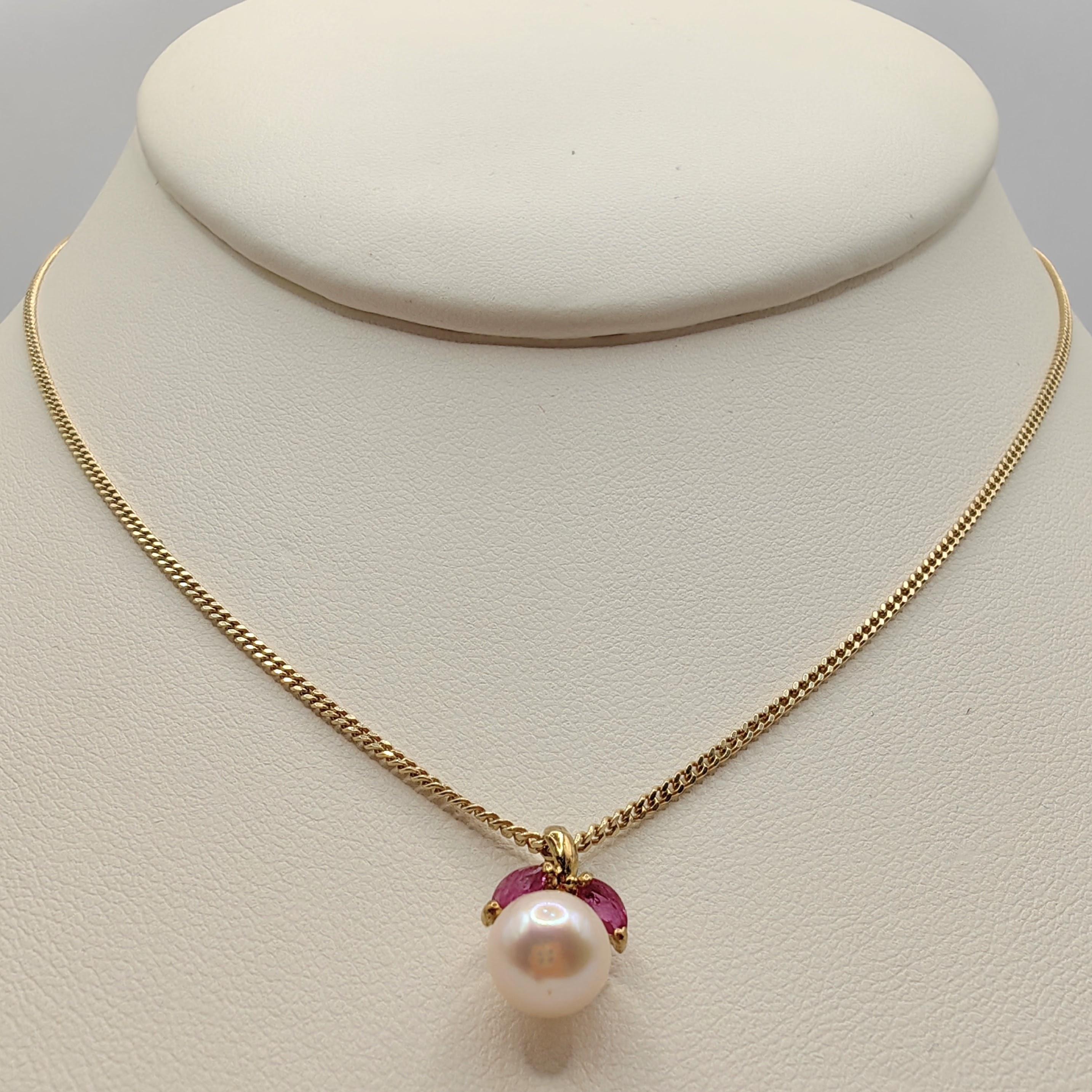 Introducing our Vintage Marquise Cut Rubies & Pearl Necklace Pendant in 14K Yellow Gold, a timeless piece of jewelry that blends vintage charm with contemporary elegance.

At the heart of this pendant lies a lustrous Freshwater Cultured Round Pearl,