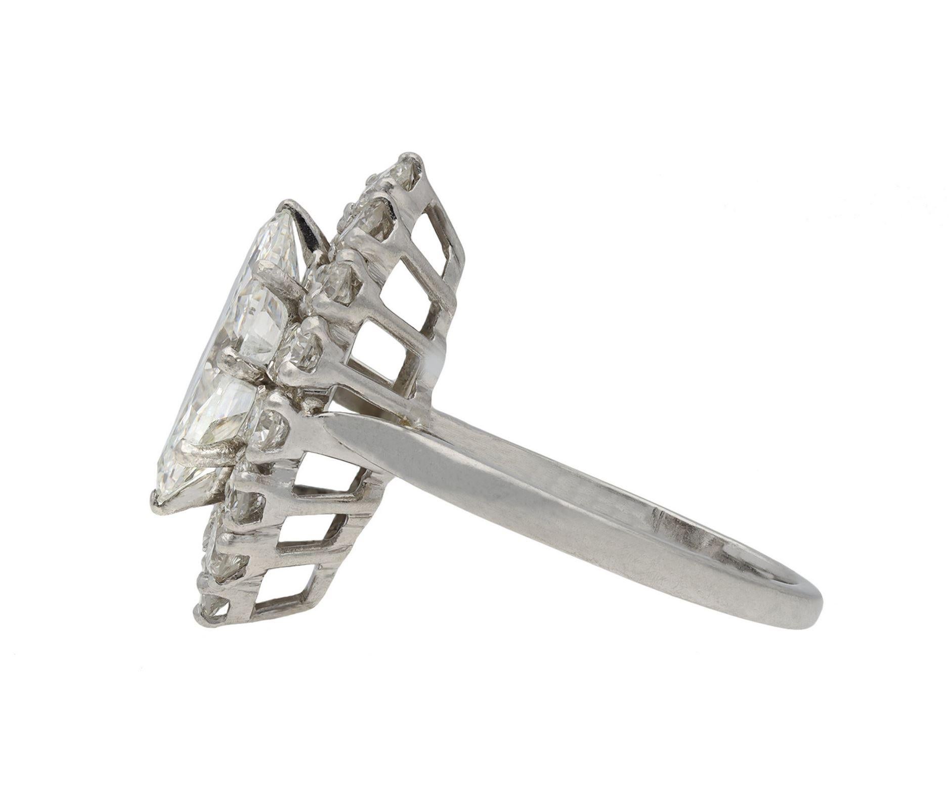 Vintage marquise diamond cluster ring. Set to centre with a marquise shape old cut diamond, F colour, VS2 clarity, with a weight of 2.39 carats in an open back claw setting, encircled by a single row of fourteen round old cut diamonds in open back