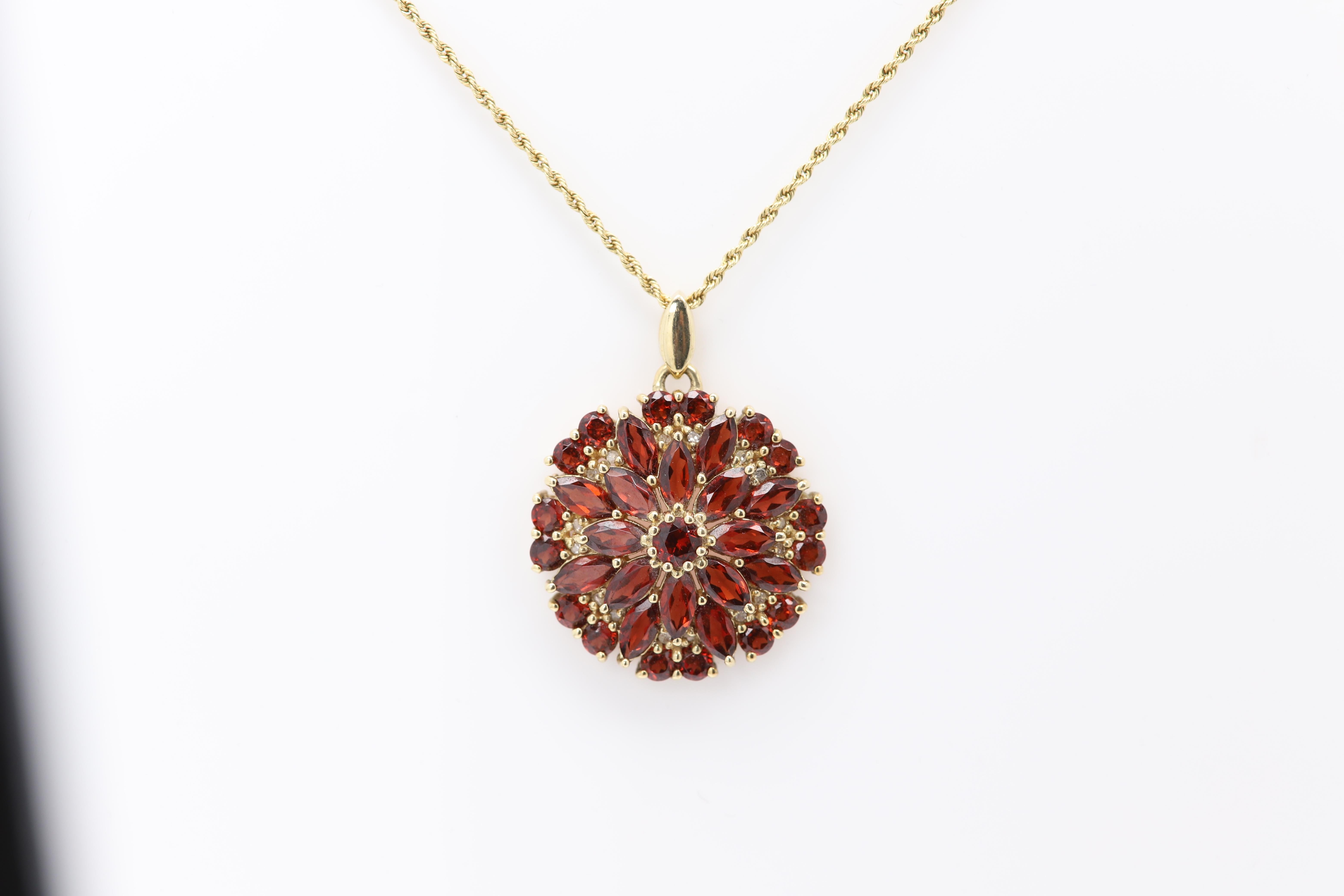 Vintage Garnet gemstone Pendant.
Brilliant Sparkling Color
Made from 10k yellow gold 
weight with the chain is approx 8.7grams
Chain is 14k and 27' inch long
Size of pendant is approx 1' Inch
Circa 1940's
Garnet stones are Gem quality and bright