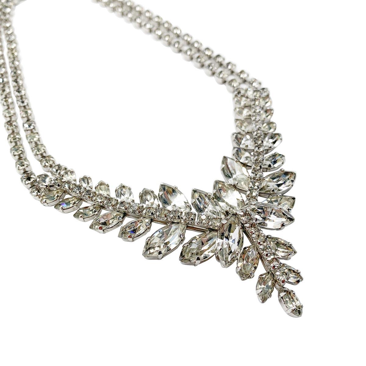 A vintage marquise rhinestone necklace. An enchanting rhinestone collar from the 1950s. Featuring a beautiful array of marquise crystals and chaton crystals in a full collar design with a very flattering V shaped front.
Featuring a wreath style of