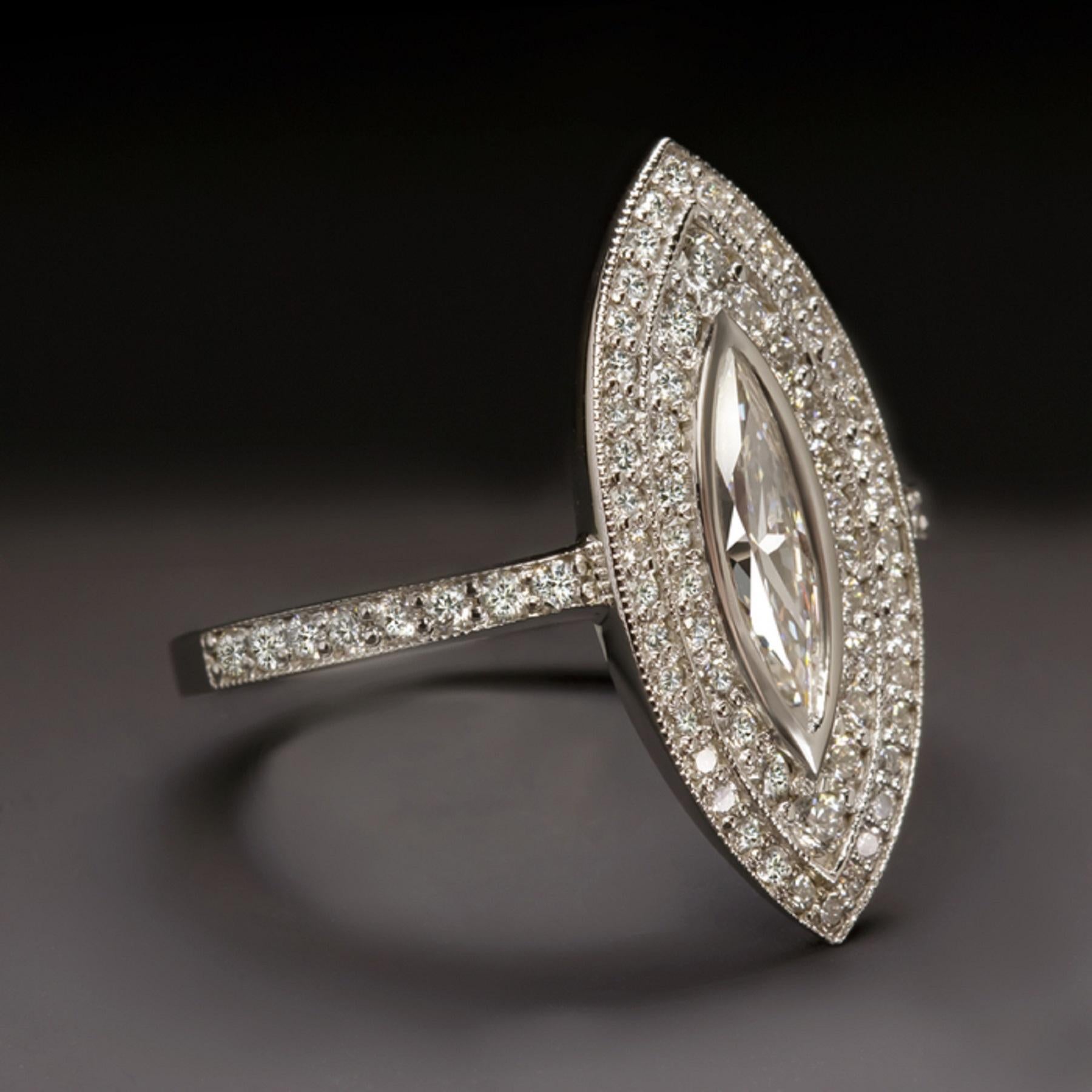 This breathtaking diamond encrusted cocktail ring is elegantly designed with an artful and elegant style and a high quality vintage marquise cut diamond center. 

Measuring an eye catching 21.7mm across, this glamorous vintage style ring will