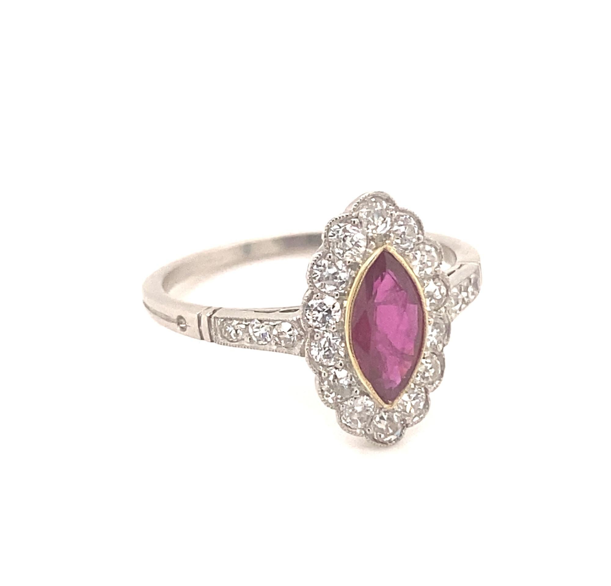This is a beautiful vintage ring set with a .65 ruby and old mine cut diamonds in a platinum setting. The ruby has a deep red color with good clarity. The 14 surrounding diamonds are fiery white old mine cuts they average I color VS2/SI-1 clarity,
