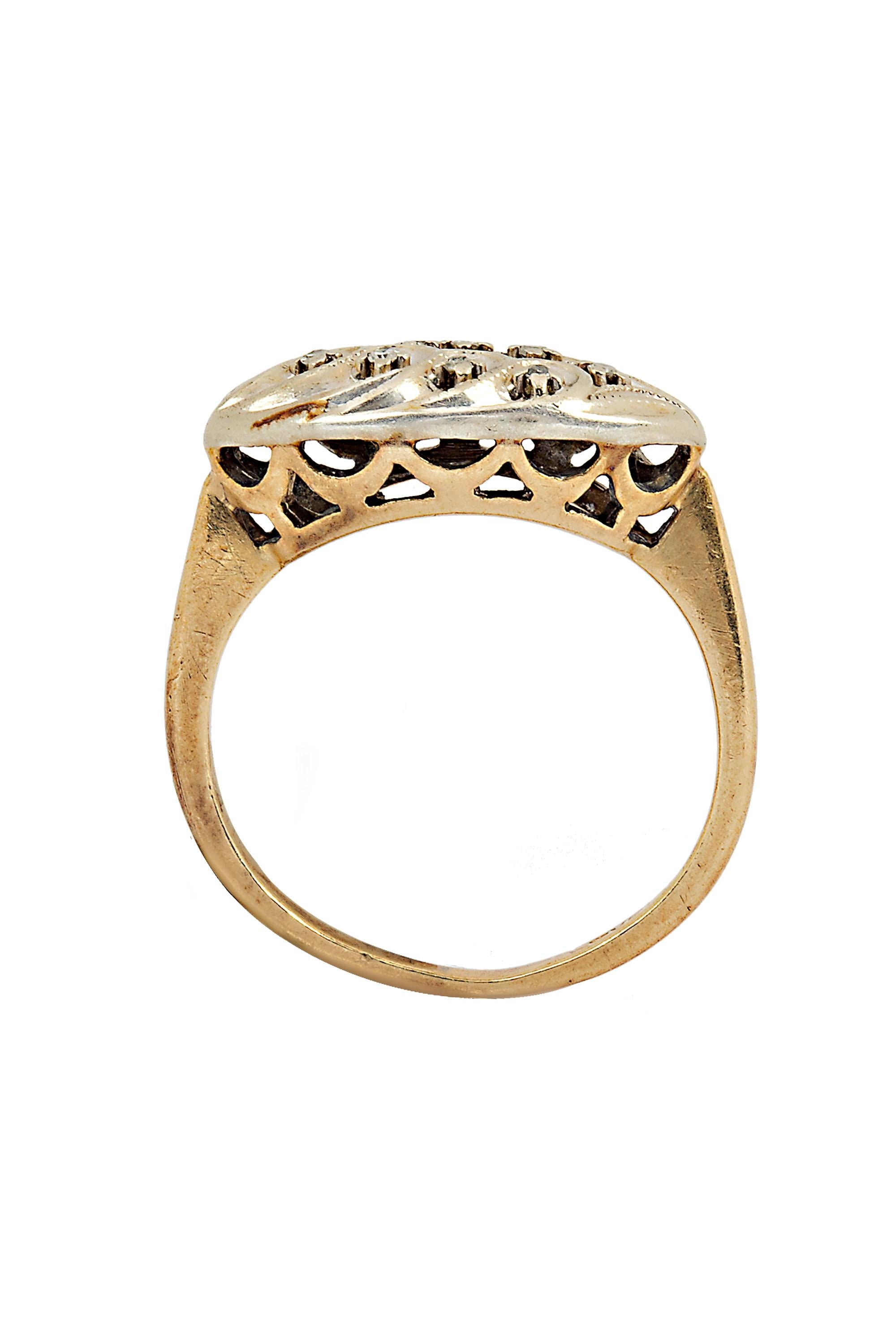 This romantic ring features a navette of eight round diamonds sparkling from within waves of sculpted white gold sitting atop an open work gallery of scalloped yellow gold. Crafted in 14 karat white and yellow gold with a total diamond weight of .08