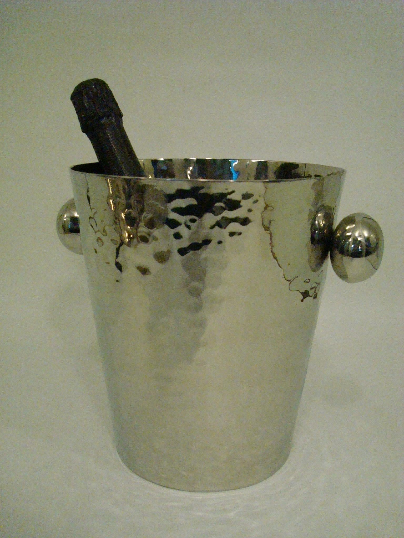 Vintage Martelé (Hammered Metal) Champagne / Wine Cooler Bucket.
 Italy 1960´s. Excellent conditions. Fits well with large bottles (the one on the pictures is a normal size bottle, not included with the cooler).
Very chic mid-century barware item. 
