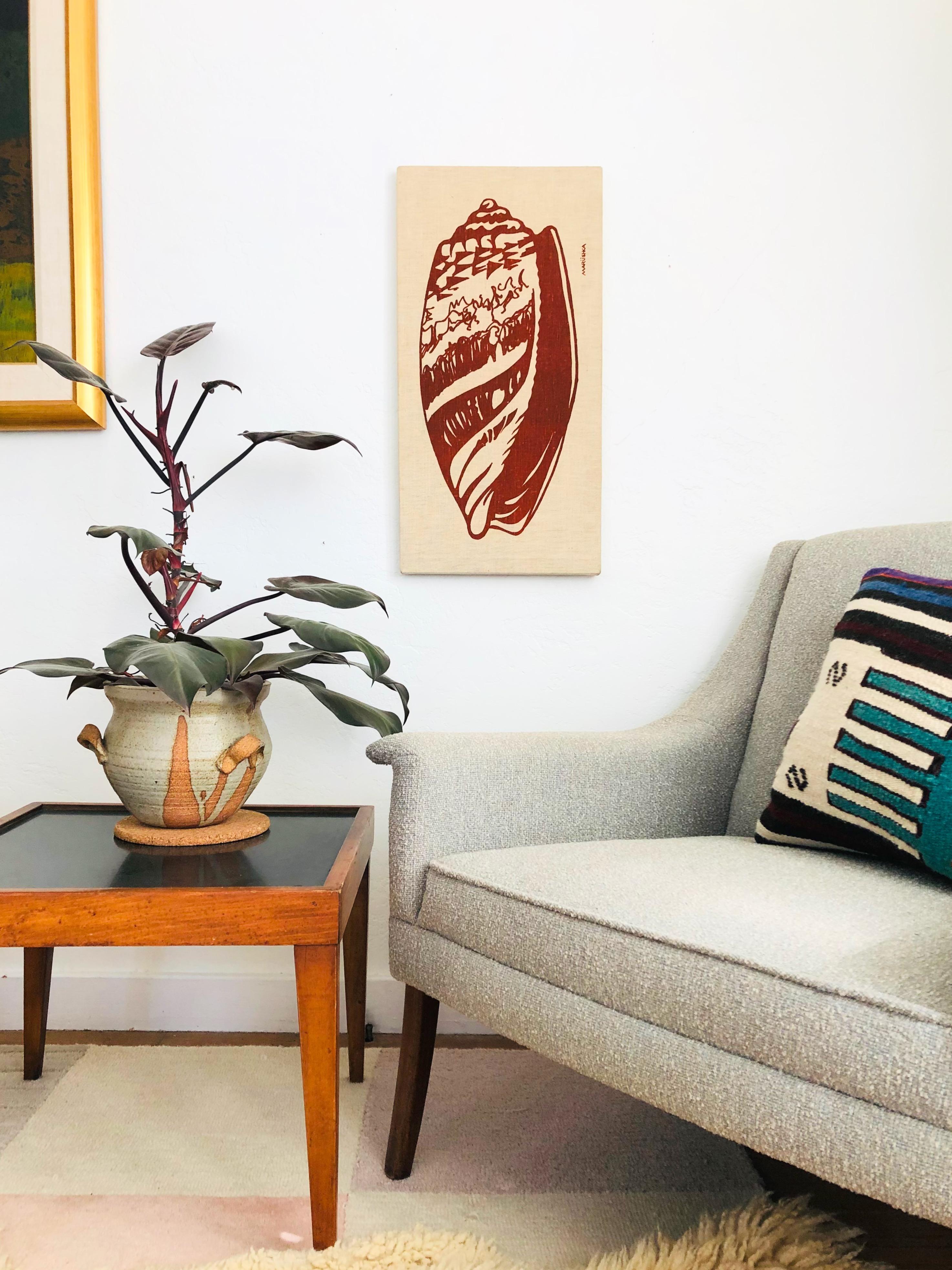 A wonderful Marüshka hand printed silkscreen from the 1970s. A bold graphic of a shell is printed on off white linen fabric wrapped on wood stretcher bars. Dated 1978 on the back. Can be hung vertically or horizontally.
 
