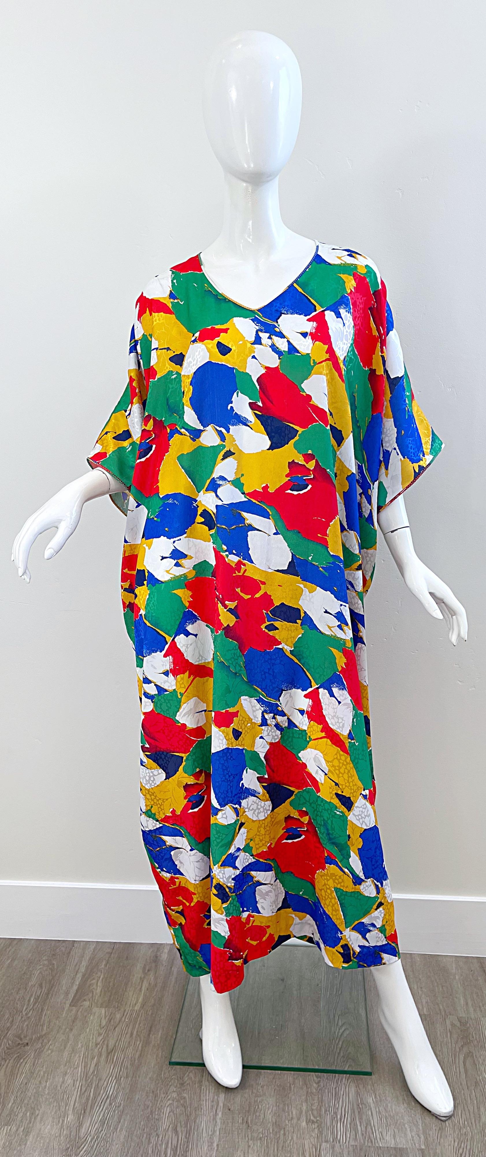 Amazing vintage MARY MCFADDEN colorful abstract print caftan ! Bright colors of blue, red, yellow, green, and white throughout. Simply slips over the head. Can be worn belted or alone. The pictured black Jane August patent leather embossed belt is