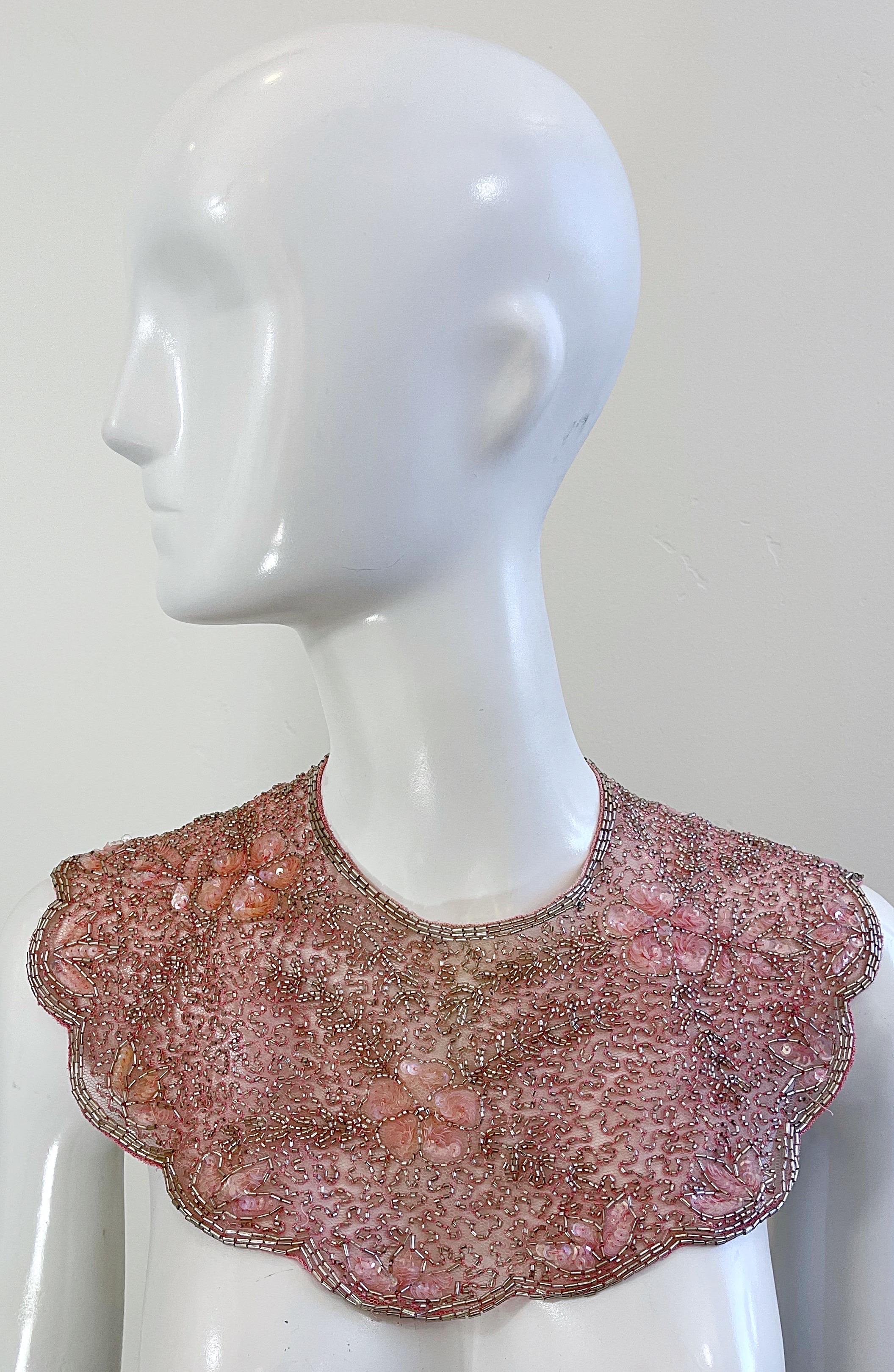 Beautiful vintage MARY MCFADDEN pink beaded and sequined collar ! Features thousands of hand-sewn sequins and beads throughout the entire piece. Hook-and-eye closures at the back neck. Can be flipped around and worn backwards as well.
In great