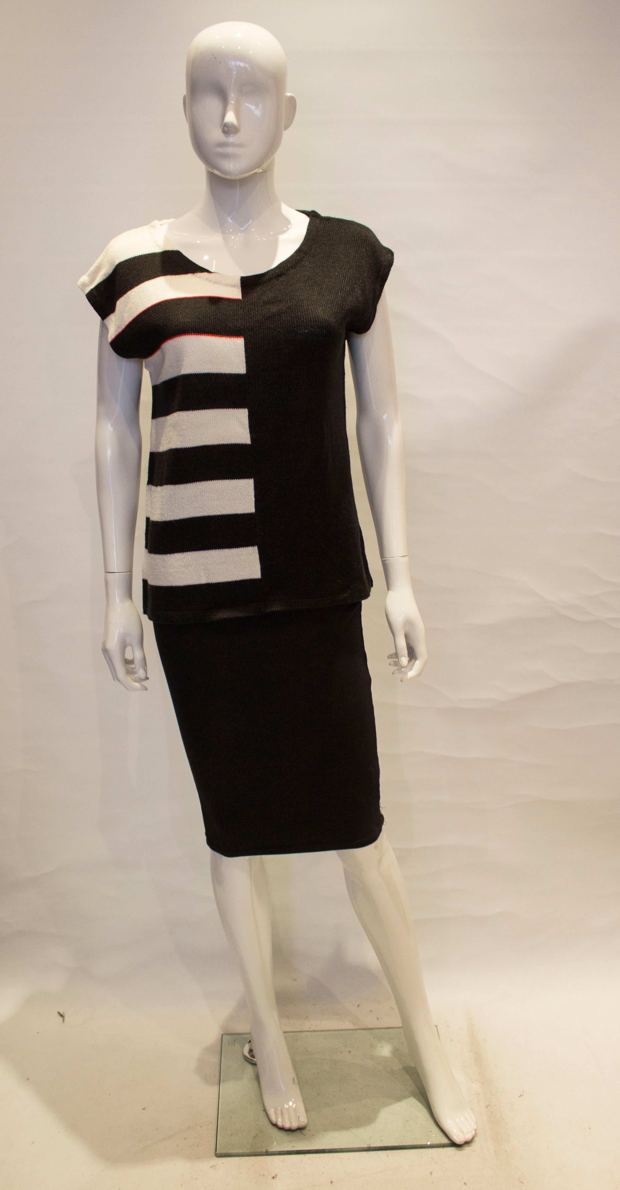 A chic vintage top by Mary Quant. The top has a round neckline and cap sleeves, and is stripes on one  half and block colour on the other, front and back.