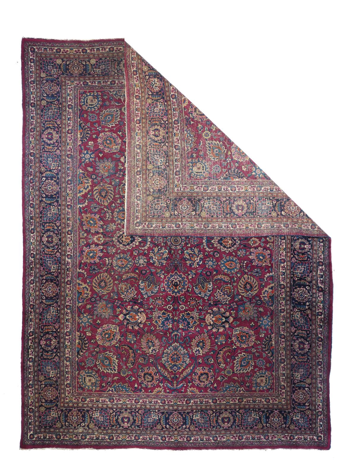 Vintage Mashad rug, measures : 9'8'' x 13'5''. The mulberry-wine red field is densely covered with a four-part centralized pattern of a bewildering assortment pf palmettes petal, crowned, ragged, boteh accented, bitonal, smooth all connected by a