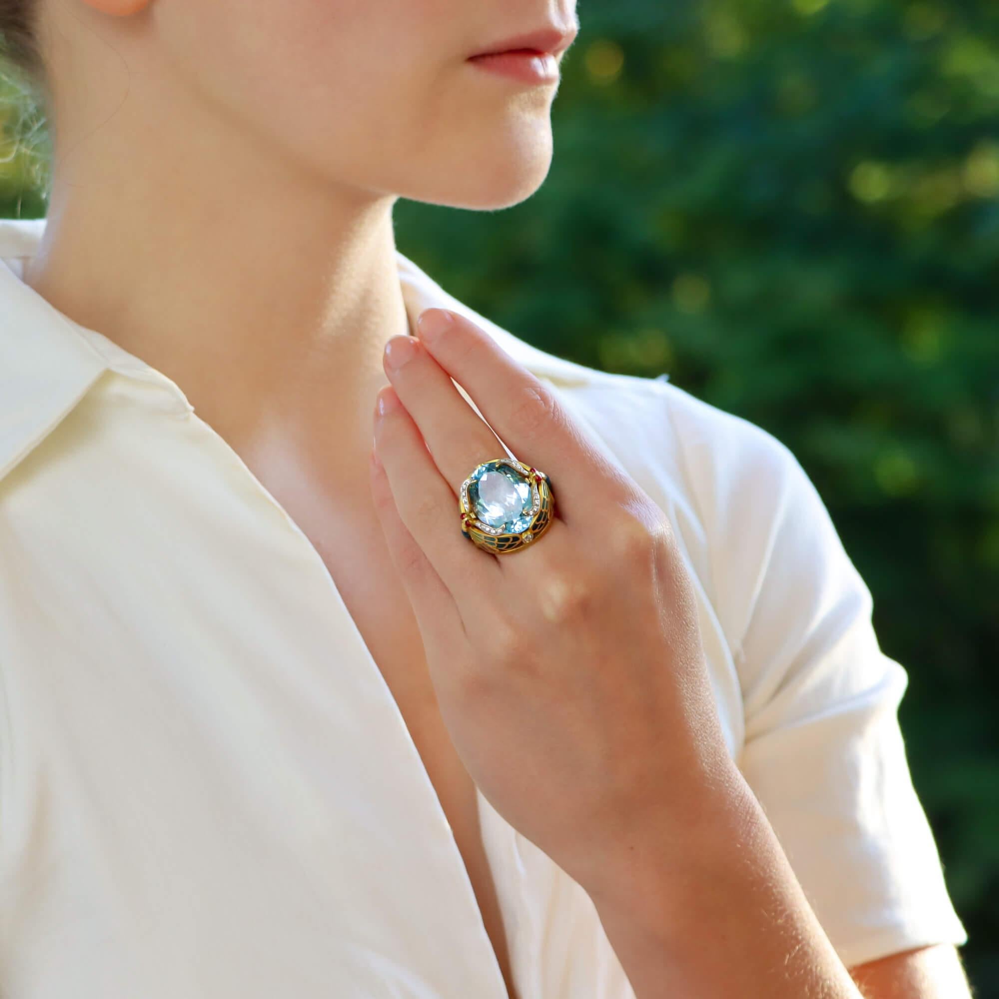 A truly magnificent vintage Masriera 'Lake Dragonflies' topaz and enamel ring set in 18k yellow gold. 

The ring is predominantly set with a 20.66 carat oval blue topaz which is encased in this beautifully handcrafted dragonfly design. The dragonfly