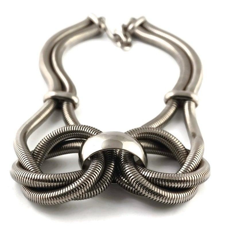 Vintage Massive CELINE Coil Knotted Snake Silver Necklace

Measurements:
Centrepiece Height: 2 4/8 inches (6.35 cms)
Wearable Length: 18 2/8 inches (46.35 cms) until 20 inches (50.80 cms)

Features:
- 100% Authentic CELINE.
- Massive CELINE coil
