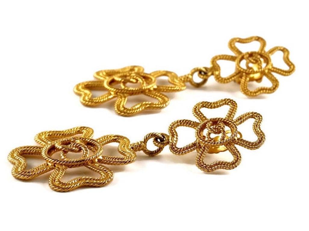 Vintage Massive CHANEL Logo Openwork Shamrock Clover Drop Earrings

Measurements:
Height: 4 2/8 inches (10.79 cm)
Width: 2 inches (5.08 cm)

Features:
- 100% Authentic CHANEL.
- Massive double shamrock/ clover drop earrings. 
- Openwork braided/