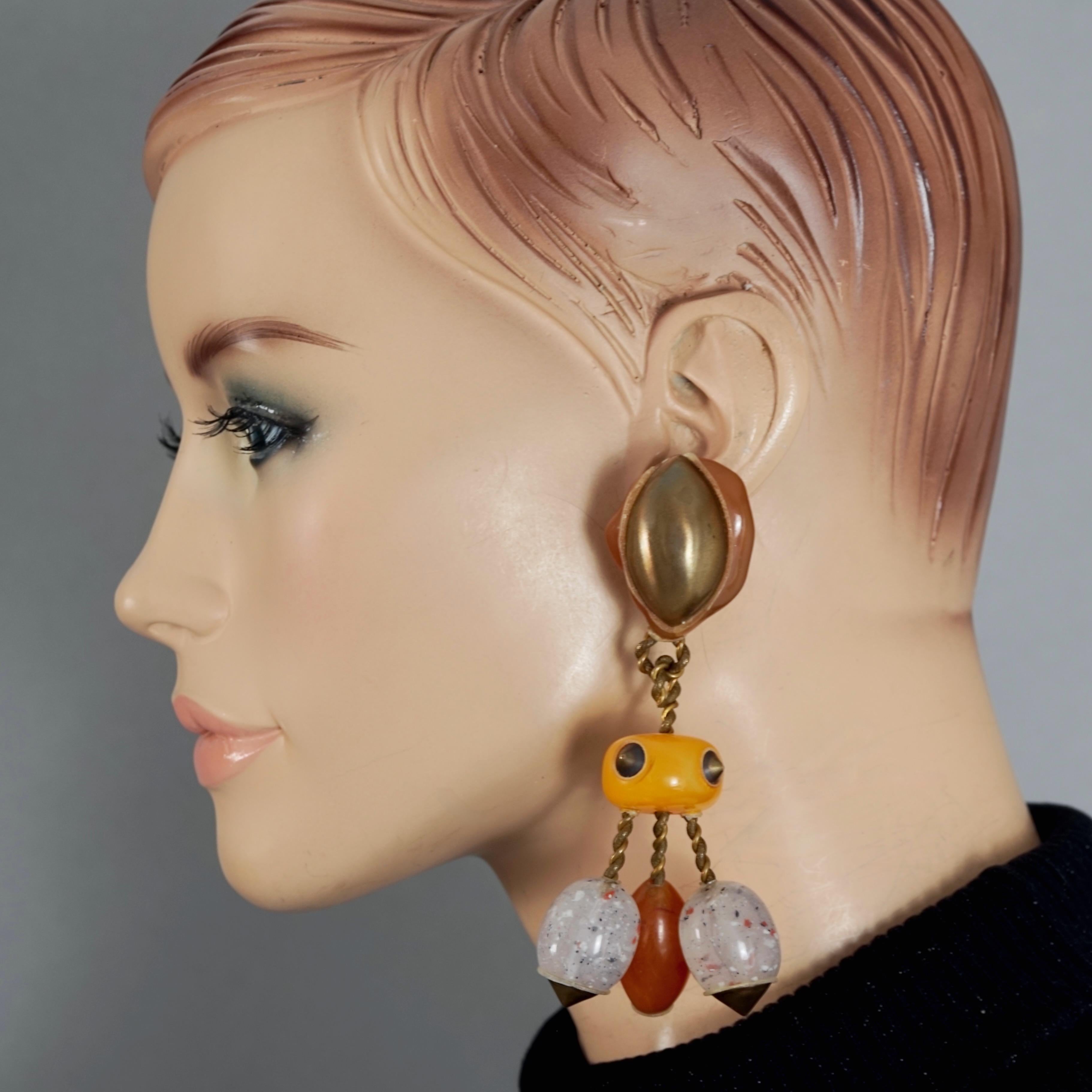 Vintage Massive CHRISTIAN LACROIX Fun Geometric Resin Dangling Earrings

Measurement:
Height: 4.53 inches (11.5 cm)
Width: 1.97 inches (5 cm)
Weight per Earring: 41 grams

Features:
- 100% Authentic CHRISTIAN LACROIX.
- Massive fun geometric resin