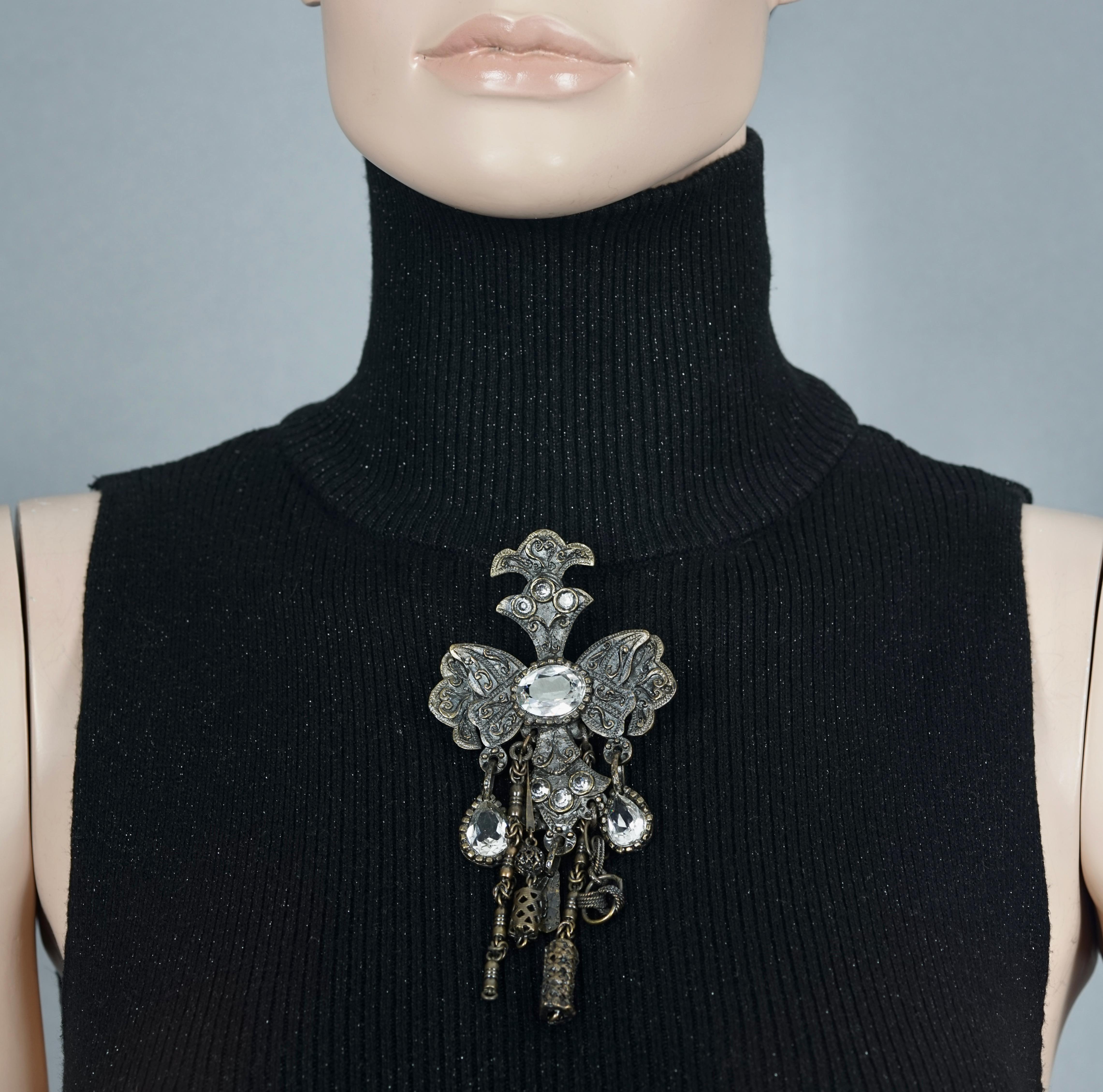 Vintage Massive CHRISTIAN LACROIX Gothic Brutalist Charm Brooch

Measurements:
Height: 5.31 inches (13.5 cm)
Width: 2.56 inches (6.5 cm)

Features:
- 100% Authentic CHRISTIAN LACROIX.
- Massive gothic brutalist charm brooch.
- Embellished with