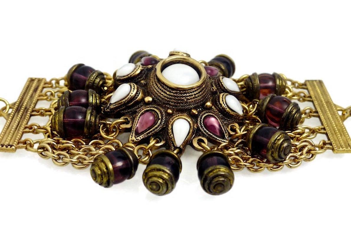 Vintage Massive Claire Deve Charm Bracelet

Measurements:
Height: 4 2/8 inches
Wearable Length: 7 4/8 inches

Features:
- 100% Authentic CLAIRE DEVE.
- Flower centre piece embellished with glass cabochons in white and purple.
- 12 purple glass
