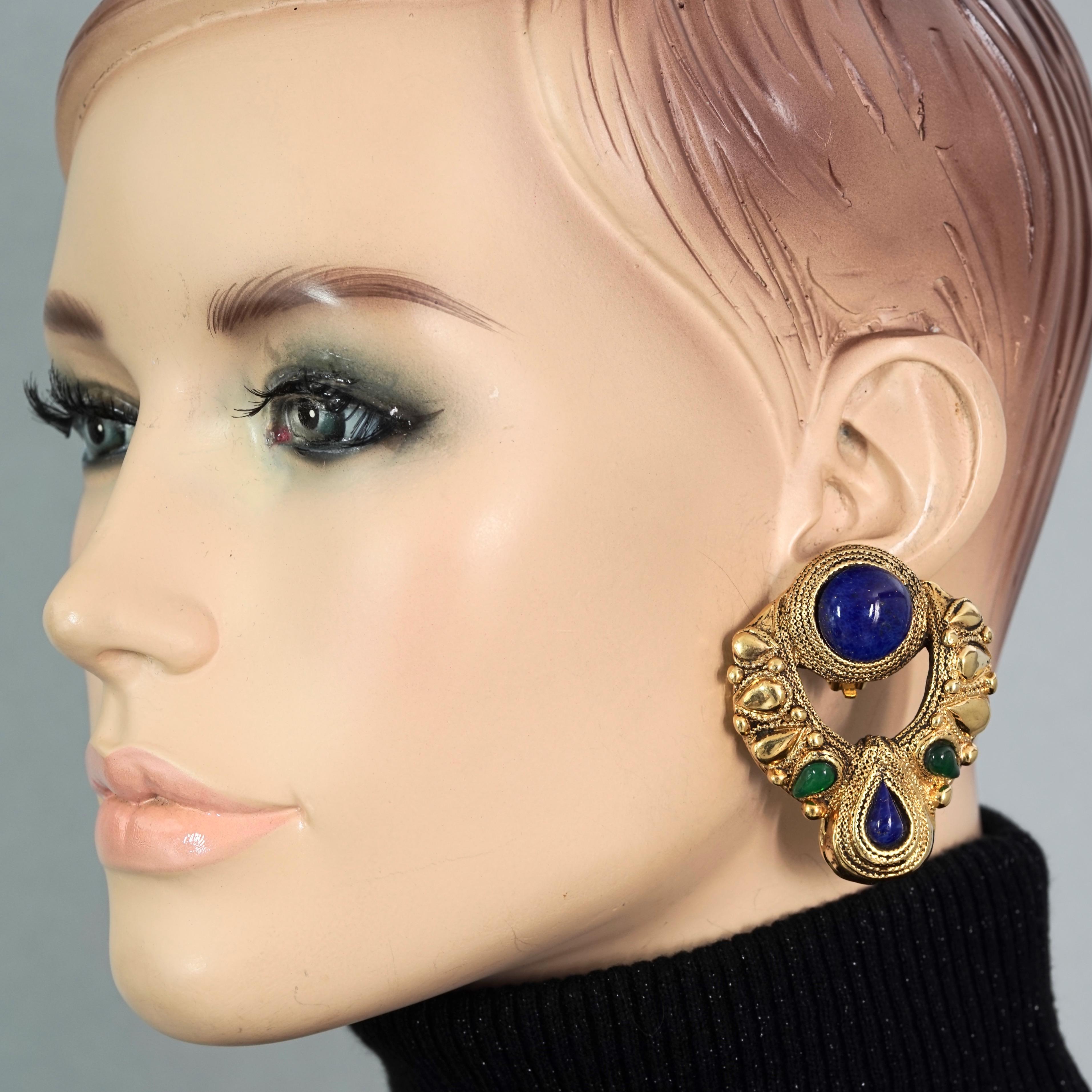 Vintage Massive CLAIRE DEVE Jewelled Door Knocker Earrings

Measurements:
Height: 2.12 inches (5.4 cm)
Width: 1.73 inches (4.4 cm)
Weight per Earring: 19 grams

Features:
- 100% Authentic CLAIRE DEVE.
- Massive jewelled door knocker earrings with
