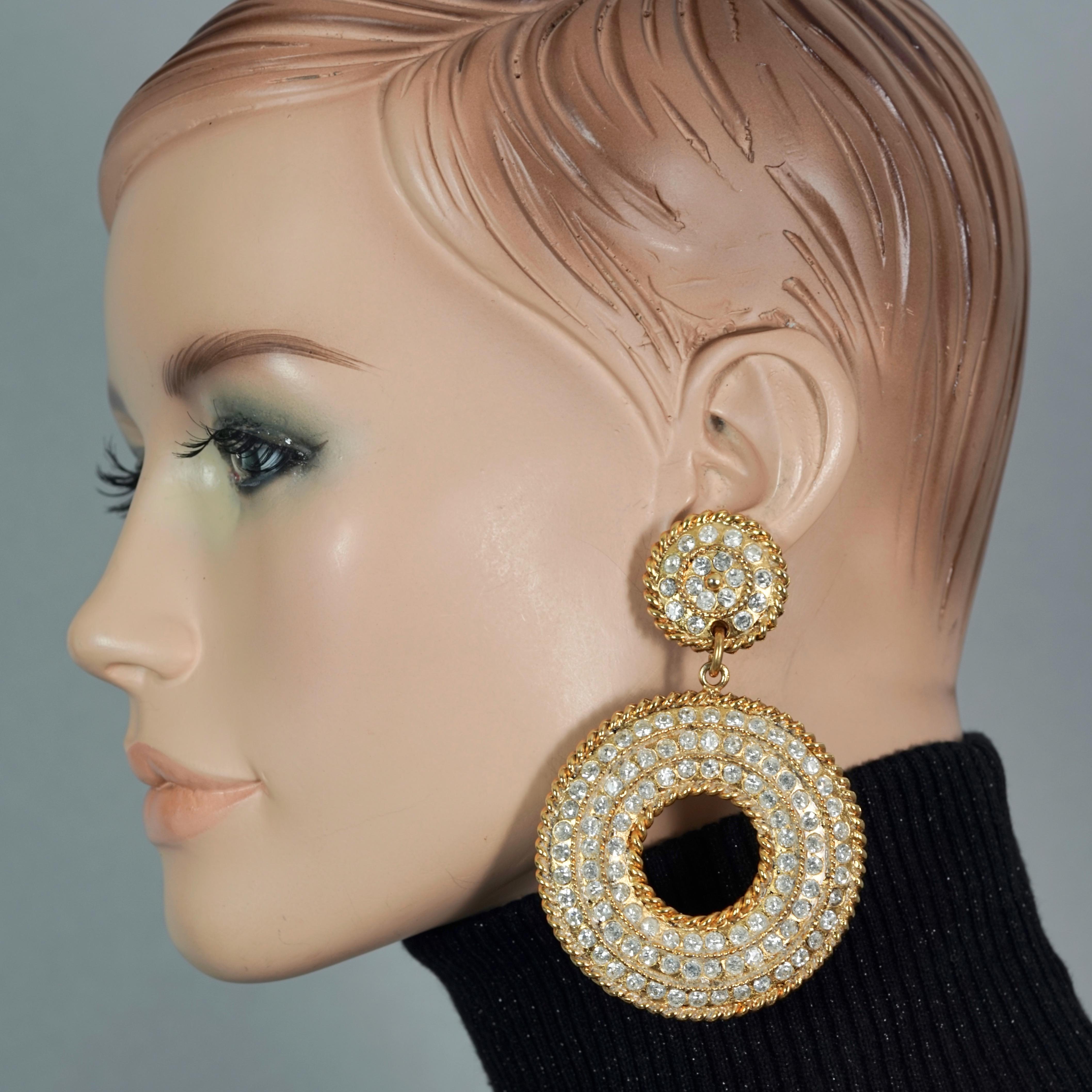Vintage Massive EDOUARD RAMBAUD Rhinestone Hoop Dangling Earrings

Measurements:
Height: 3.46 inches (8.8 cm)
Width: 2.40 inches (6.1 cm)
Weight: 34 grams

Features:
- 100% Authentic EDOUARD RAMBAUD.
- Massive hoop dangling earrings studded with