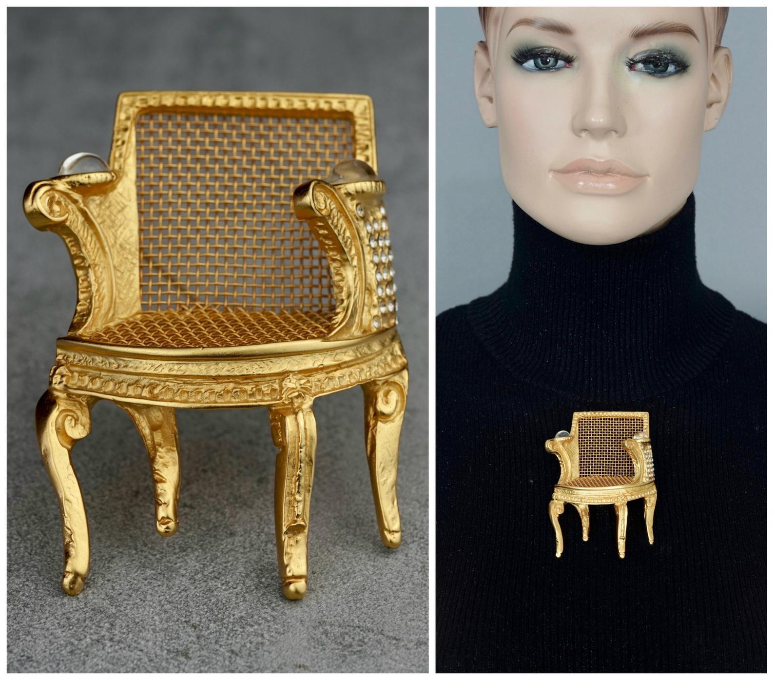 Vintage Massive KARL LAGERFELD Louis XVI Chair Brooch

Measurements:
Height: 3.54 inches (9 cm)
Width: 2.44 inch (6.2 cm)
Depth: 0.98 inch (2.5 cm)

Features:
- 100% Authentic KARL LAGERFELD.
- Massive Louis XVI style chair.
- Embellished with clear