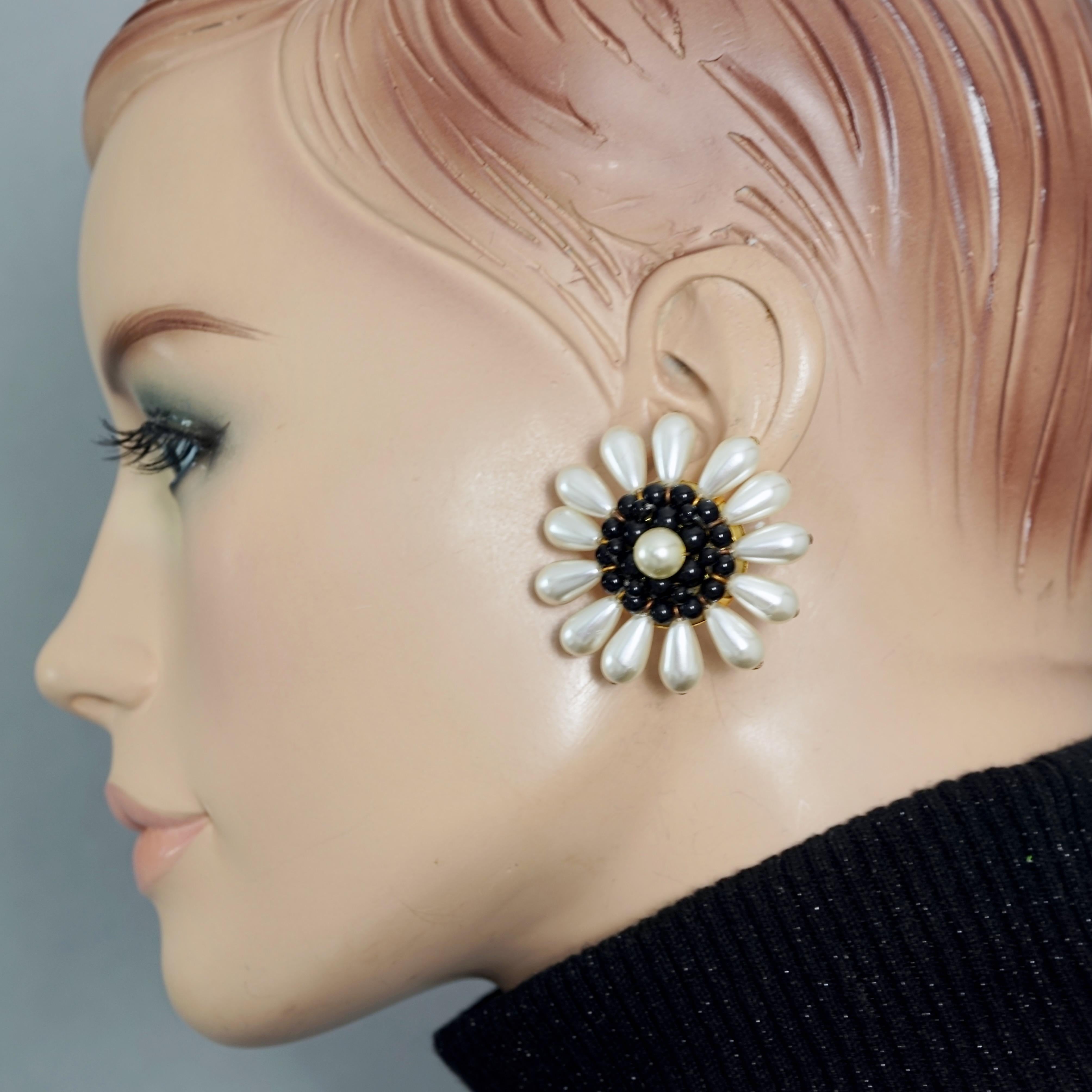 Vintage Massive LOUIS FERAUD Flower Pearl Earrings

Measurements:
Height: 1.73 inches (4.4 cm)
Width: 1.73 inches (4.4 cm)
Weight per Earring: 11 grams

Features:
- 100% Authentic LOUIS FERAUD.
- Massive flower earrings with pearls and glass