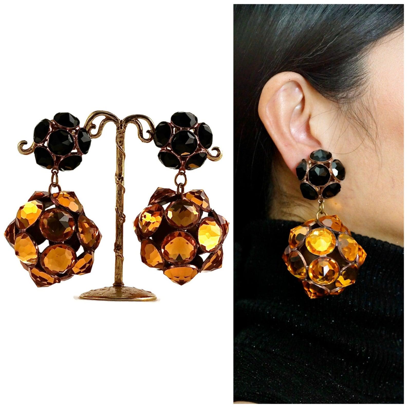 Vintage Massive YSL Yves Saint Laurent Disco Ball Rhinestone Flower Earrings

Measurements:
Height: 3 3/8 inches
Width: 2 inches

Features:
- 100% Authentic YVES SAINT LAURENT.
- Top part is black faceted rhinestones in flower form.
- Bottom part is