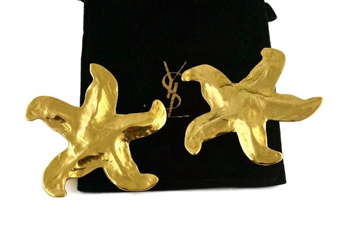 Vintage Massive YVES SAINT LAURENT Starfish Earrings

Measurements:
Height: 2 3/8 inches
Width: 2 4/8 inches

Features:
- 100% Authentic YVES SAINT LAURENT.
- Starfish/ star earrings.
- Clip back earrings.
- Gold tone.
- Marked YSL Made in France at