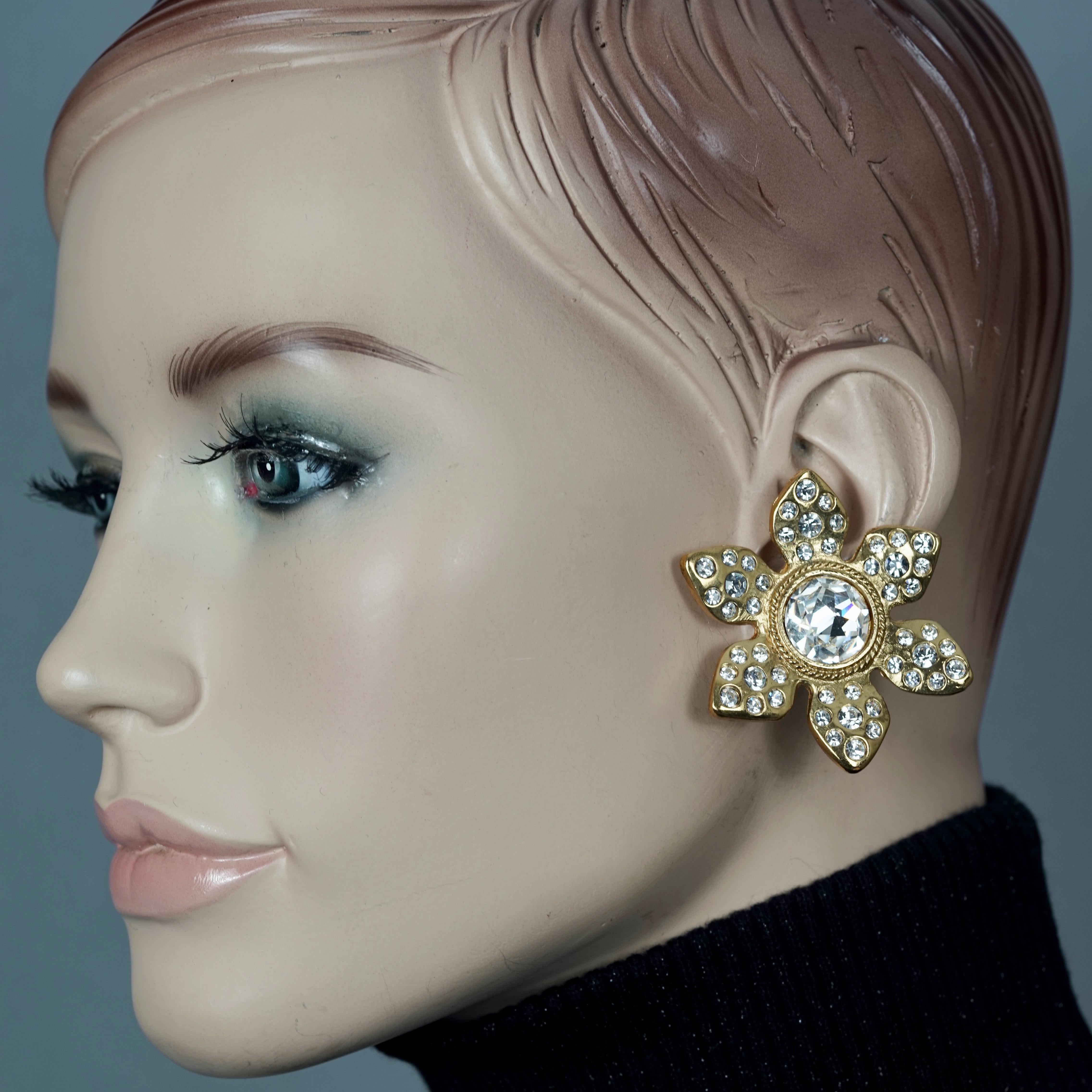 Vintage Massive YVES SAINT LAURENT Ysl Flower Rhinestone Earrings

Measurements:
Height: 2 inches (5 cms)
Width: 2 inches (5 cms)
Weight per Earring: 26 grams

Features:
- 100% Authentic YVES SAINT LAURENT.
- Massive flower earrings studded with