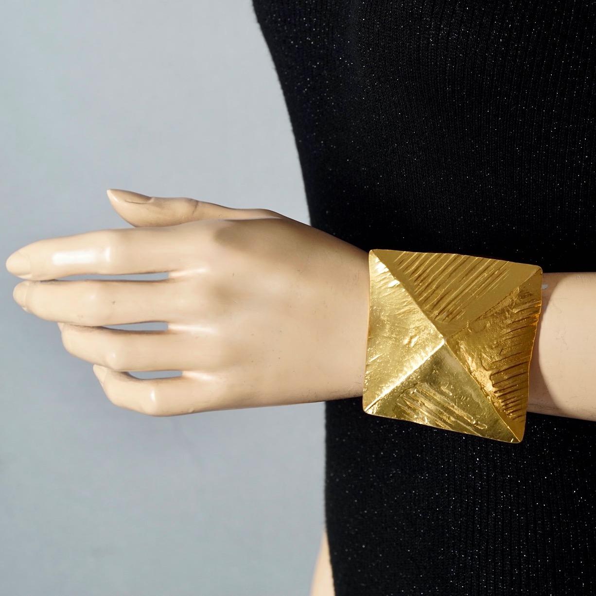 Vintage Massive YVES SAINT LAURENT Ysl Pyramid Textured Cuff Bracelet

Measurements:
Height: 2.56 inches (6.5 cm)
Inner Circumference: 6.69 inches (17 cm) opening included

Features:
- 100% YVES SAINT LAURENT.
- Massive textured cuff bracelet with