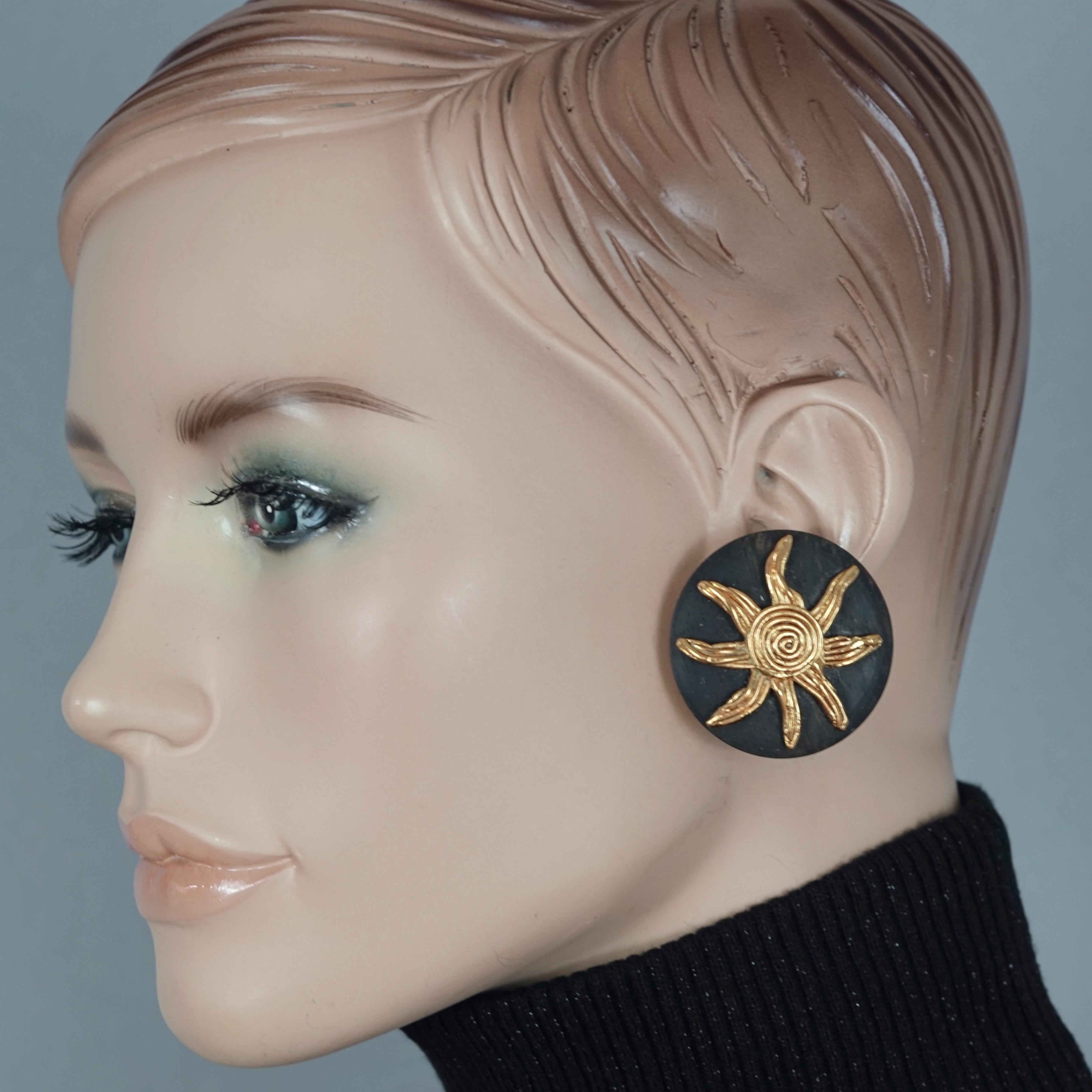 Vintage Massive YVES SAINT LAURENT Ysl Spiral Sun Disc Wood Earrings

Measurements:
Height: 1.61 inches (4.1 cm)
Width: 1.61 inches (4.1 cm)
Weight: 23 grams

Features:
- 100% Authentic YVES SAINT LAURENT.
- Textured sun in spiral pattern overlay on
