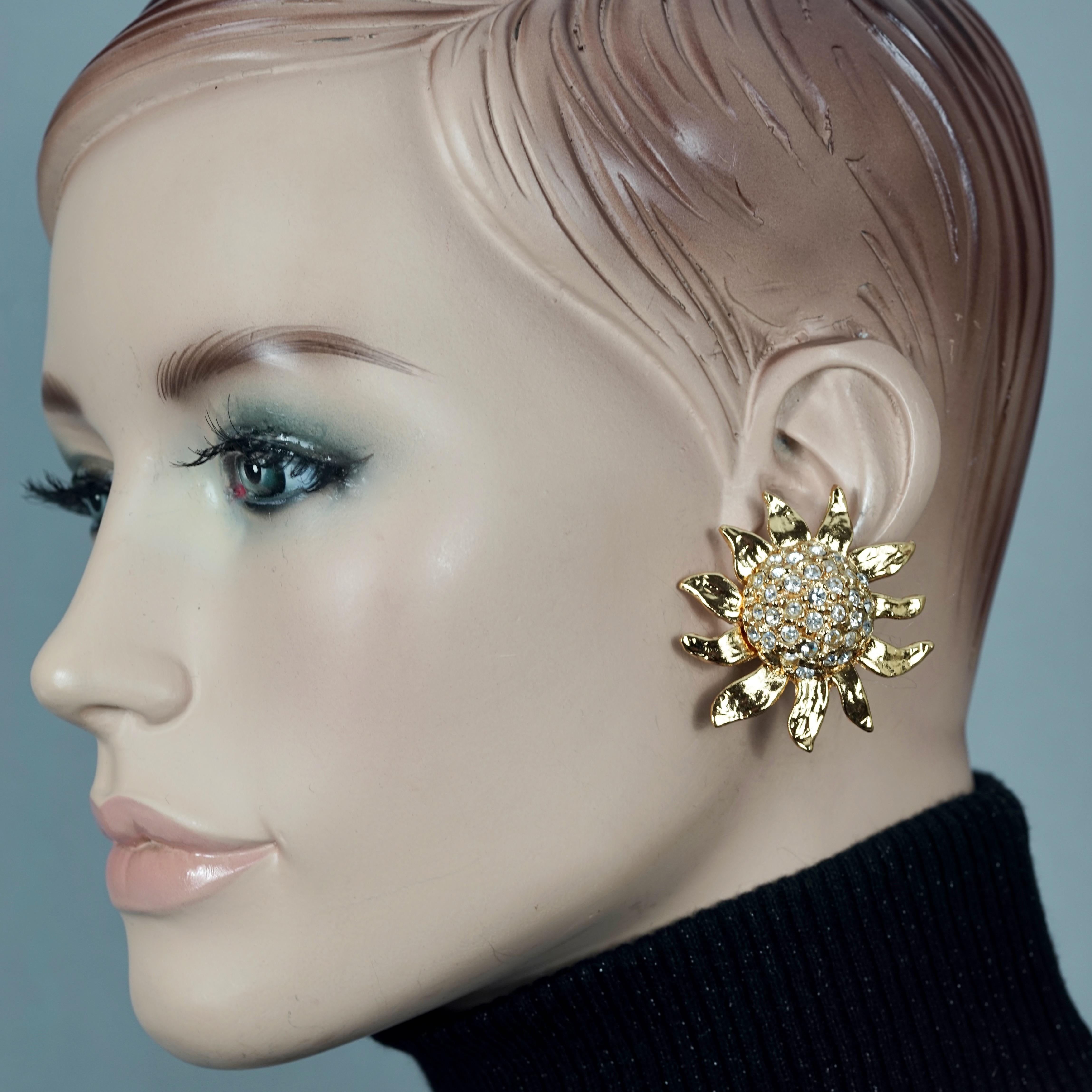 Vintage Massive YVES SAINT LAURENT Ysl Sunflower Earrings

Measurements:
Height: 1.77 inches (4.5 cm)
Width:  1.77 inches (4.5 cm)
Weight: 20 grams

Features:
- 100% Authentic YVES SAINT LAURENT.
- 3D sunflower earrings with studded rhinestones.
-