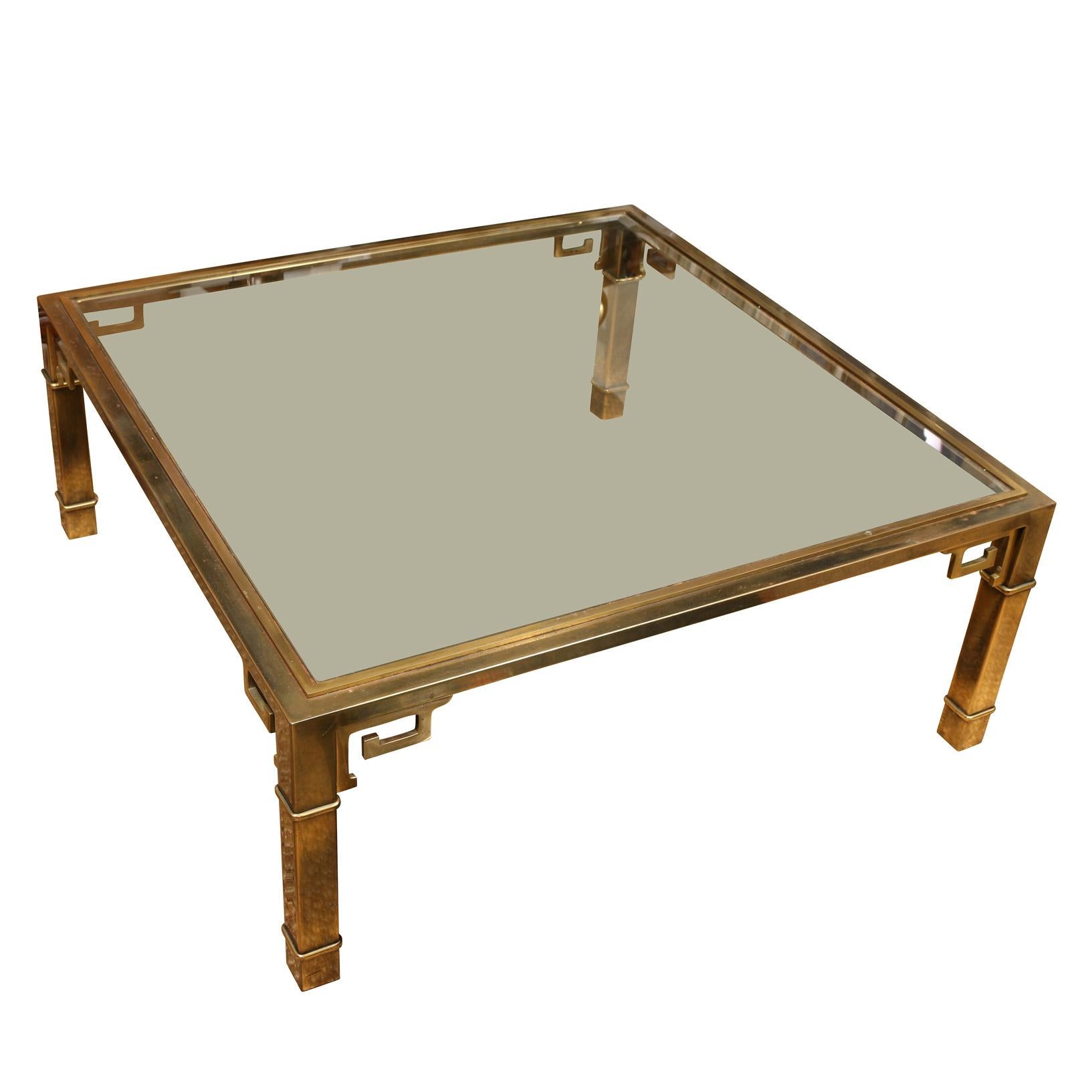 Circa 1970 Mastercraft square Asian style coffee table of bronze patinated brass and beveled glass top with fretwork design to apron.