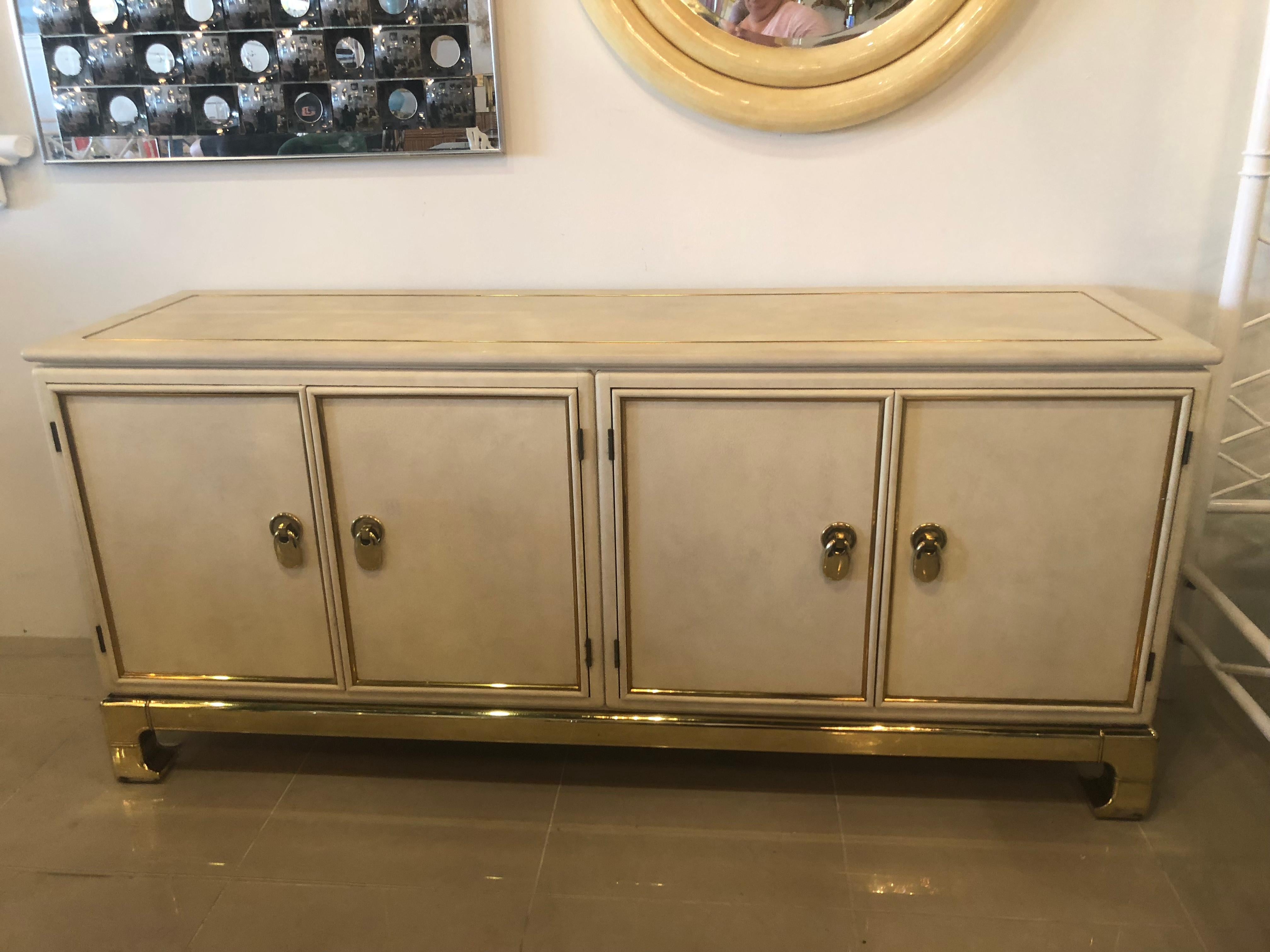 Vintage Mastercraft credenza, tagged on the back (pictured). Double doors on each side with shelf on each side, one side has a drawer also (pictured). Brass finish does have some discoloration (pictured). The inside of the cabinet does have scuffs