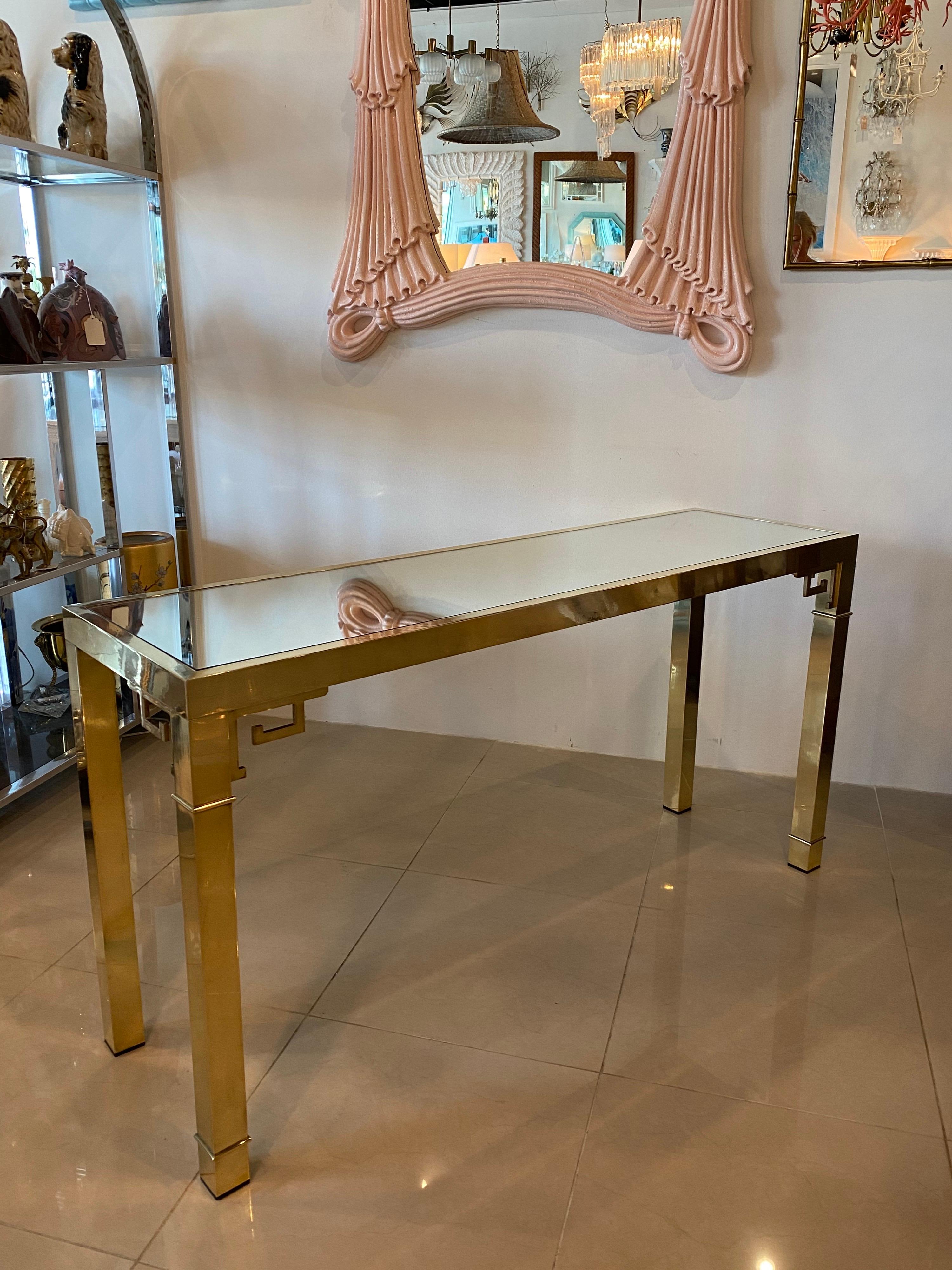 Lovely vintage Mastercraft Greek key polished brass console table with new mirror top. Polished with some patina.