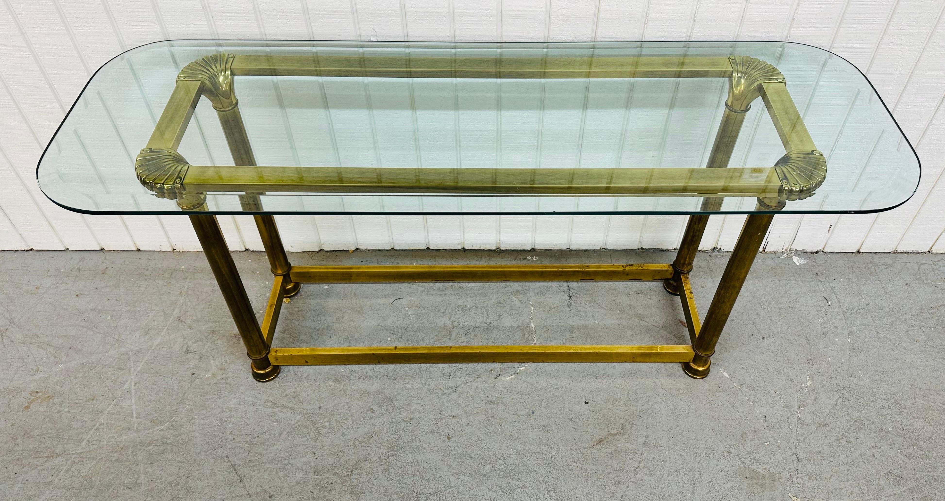 This listing is for a vintage Mastercraft Style Brass & Glass Sofa Table. Featuring a heavy brass base, a shell design on each corner, and a beveled glass top. This is an exceptional combination of quality and design!