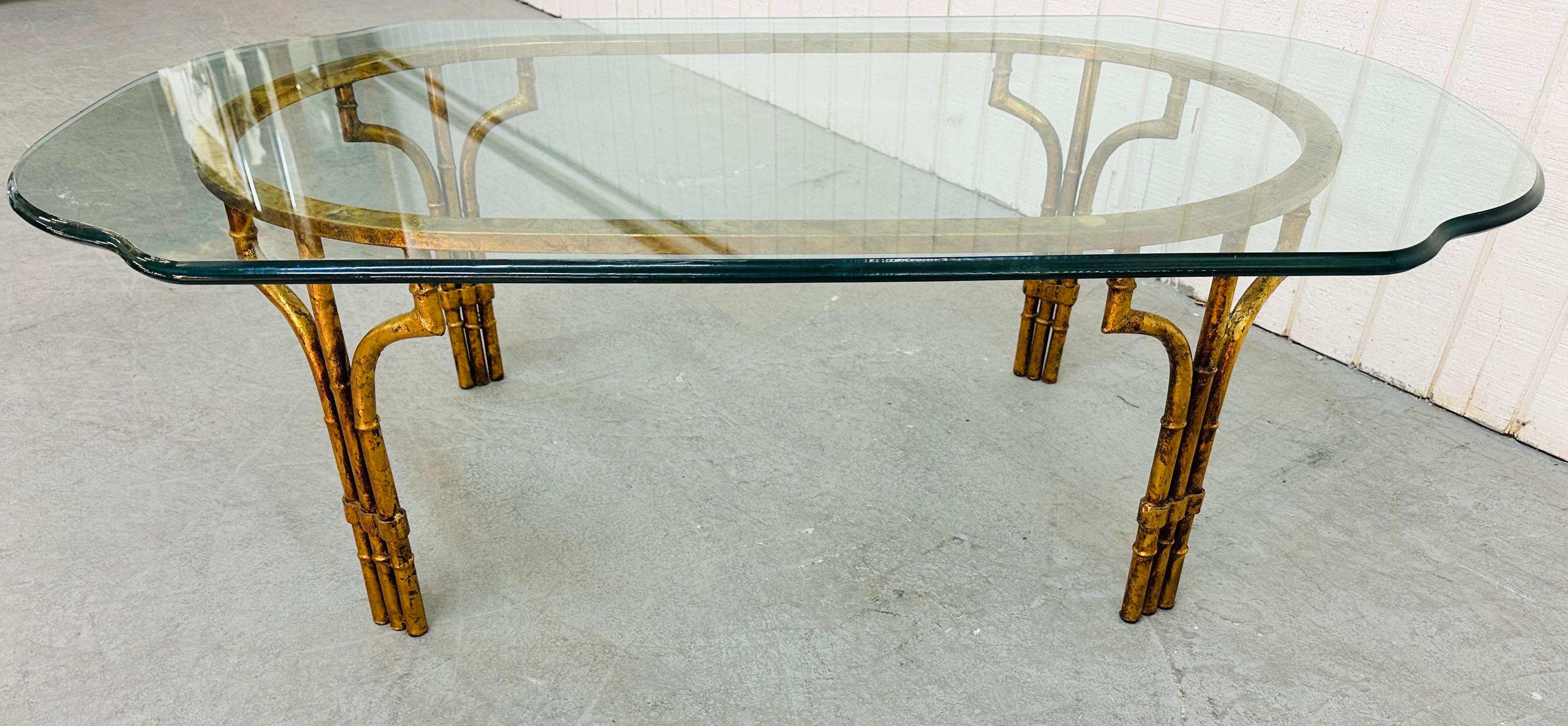 This listing is for a vintage Mastercraft Style Faux Bamboo Glass Top Coffee Table. Featuring a turtle shell shaped glass top, oval gold gilt faux bamboo base and four legs.