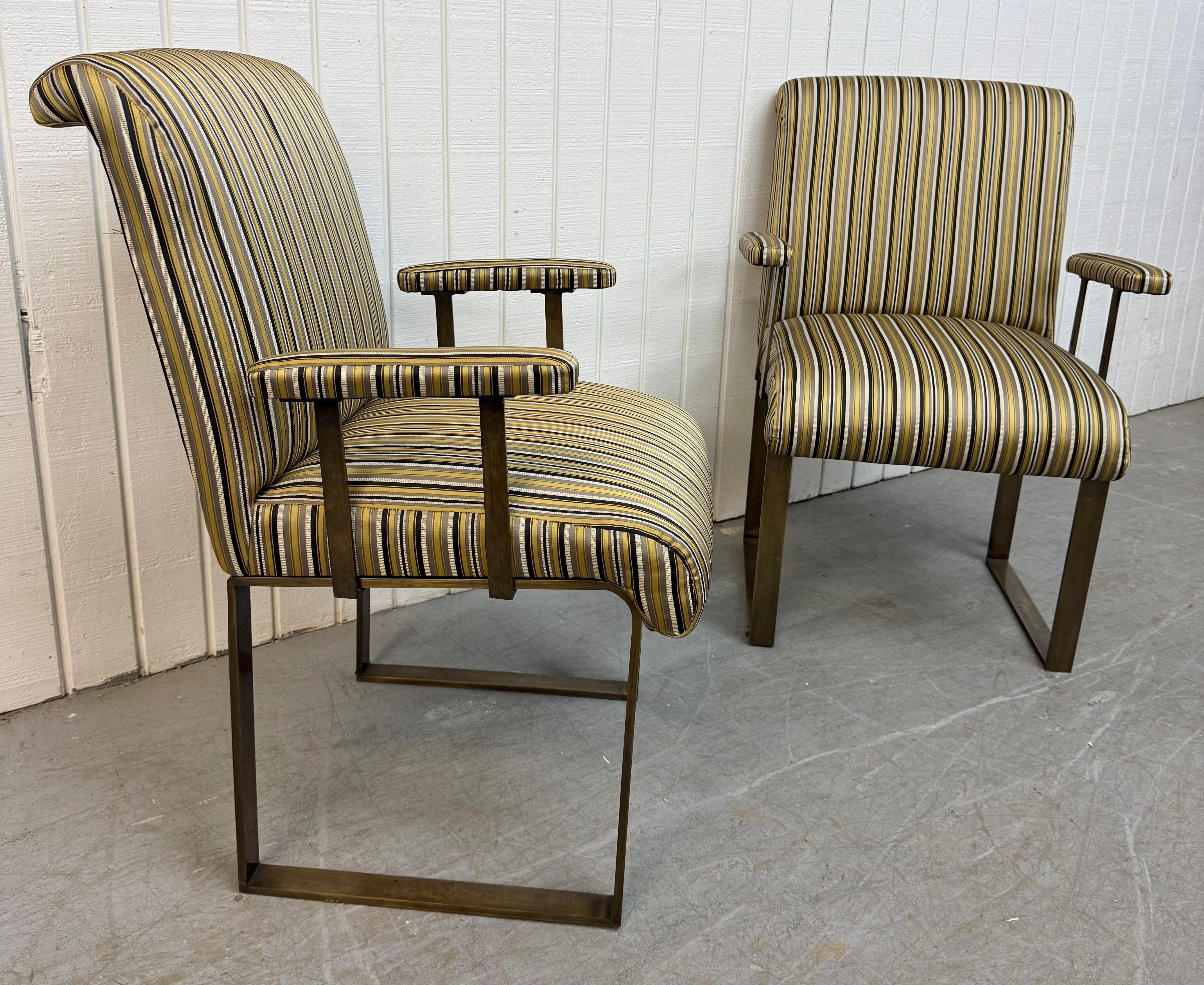 This listing is for a pair of Vintage Mastercraft Upholstered Brass Arm Chairs. Featuring a heavy flat bar frame, padded arm rests, and newly pin striped upholstery. This is an exceptional combination of quality and design!