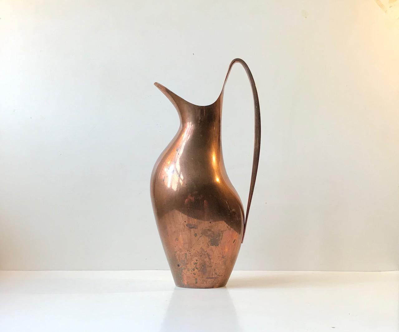 Important HK piece for Georg Jensen in Denmark. It is called Masterpiece and has been nicknamed 'The Pregnant Duck' pitcher. It was designed by the danish silversmith and architect Henning Koppel in 1954. Initially it came in stainless steel and