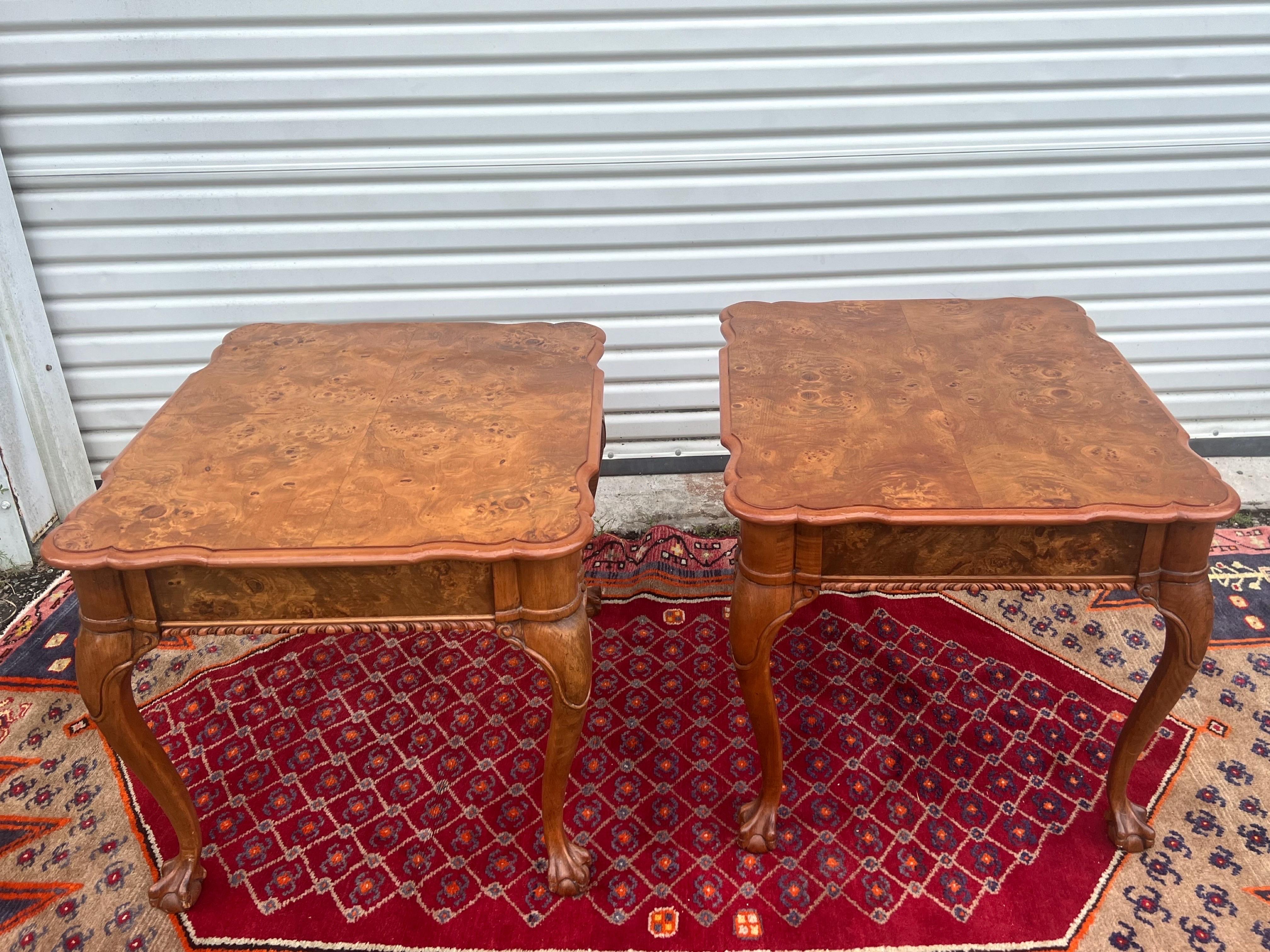 A fantastic stunning pair of matchbook burl side tables with each having a single drawer and sitting on ball and claw feet. Made by Weiman Furniture.
 