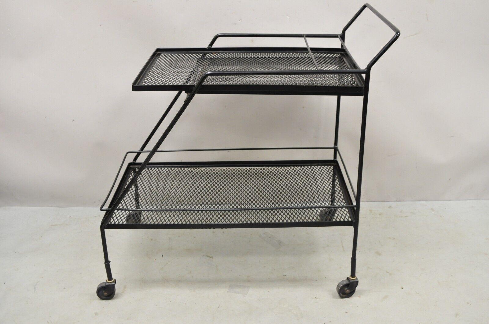 Vintage Mathieu Mategot Style Black Wrought Iron 2 Tier Modern Bar Cart Trolley. Item features a removable serving tray, 2 tiers, metal mesh iron frame, black finish, wrought iron construction, very nice vintage item, clean modernist lines, great