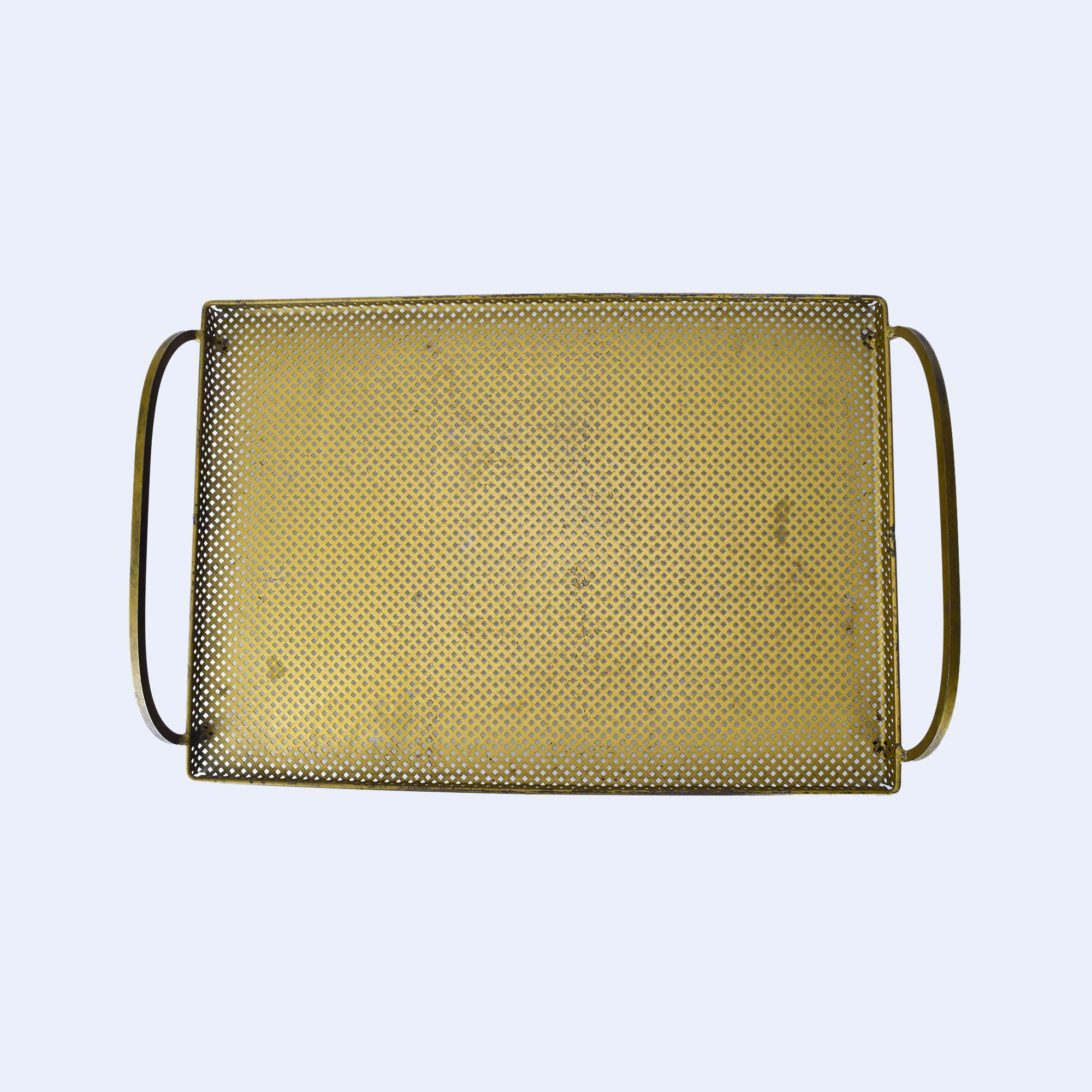 This elegant vintage tray in the style of Mathieu Mategot features a beautifully perforated metal design, adding texture and visual interest. The rectangular shape is framed by gently rounded handles on either side, providing both functionality and